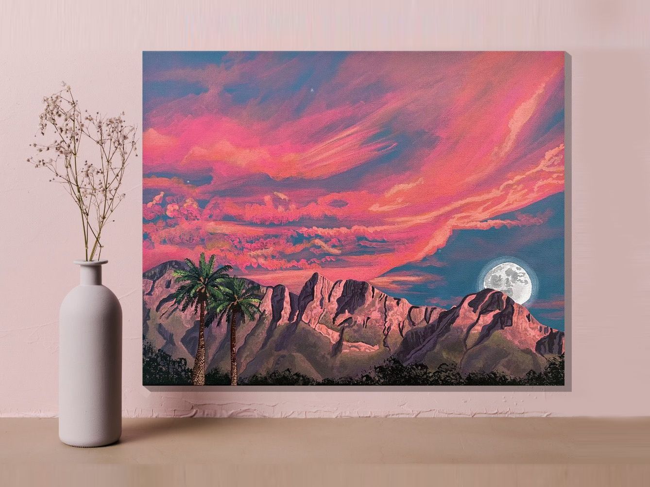 A painting of the moon setting behind the Catalina Mountains in Tucson, Arizona. Pink and orange clouds fill the sky. Three stars grace the sky. Palm trees in front of the mountains.
