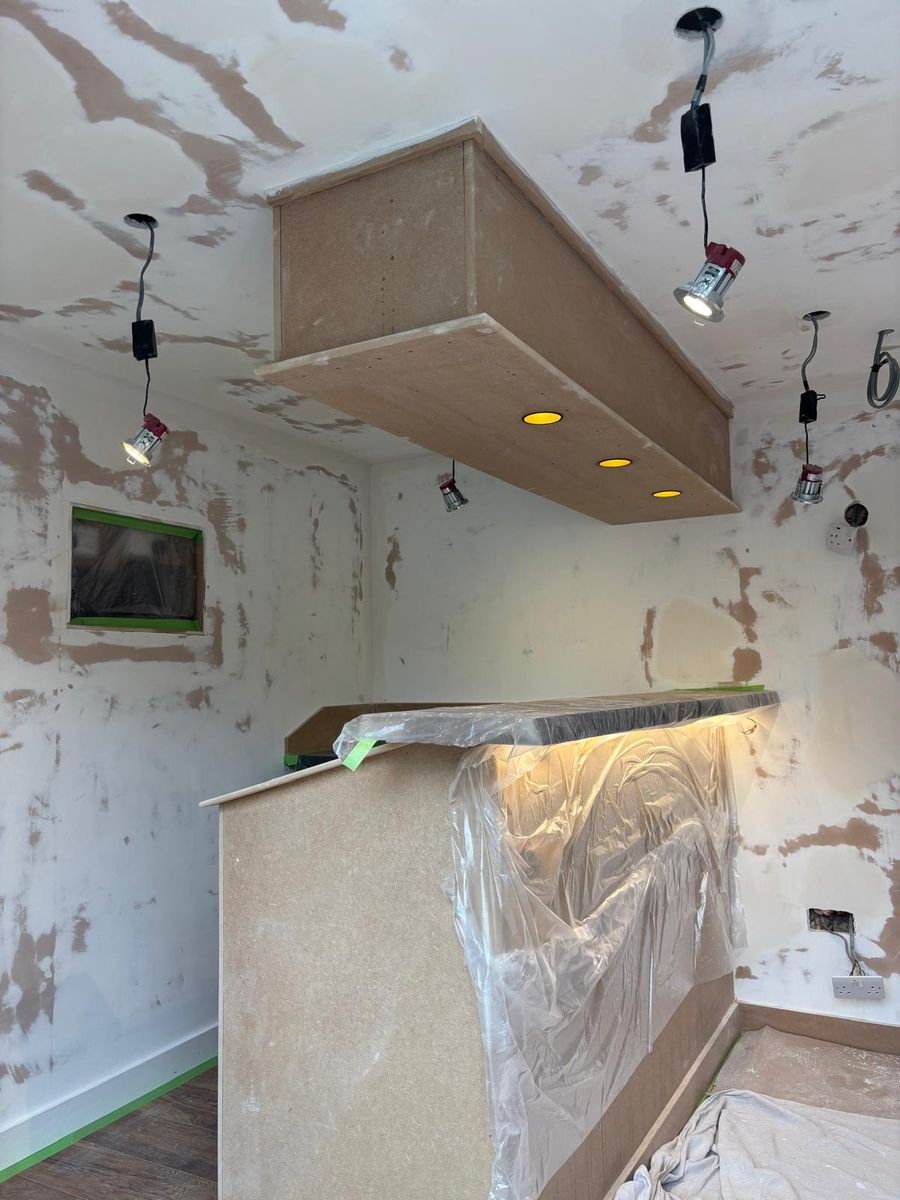 Mid-build: the bar carcass and lighting canopy in place, walls filled ready for decoration.