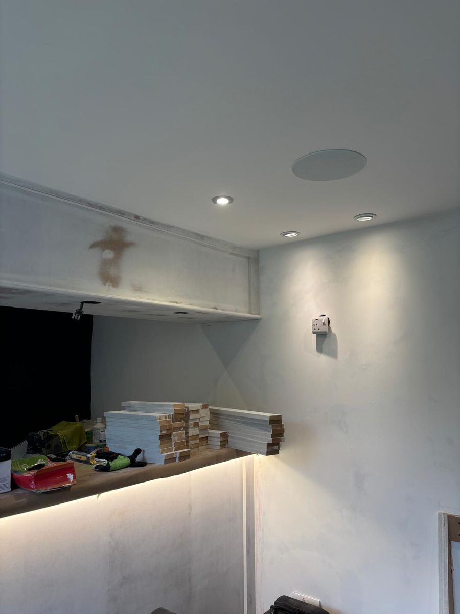 Ceiling speakers and downlights in, panelling stacked ready for fitting.