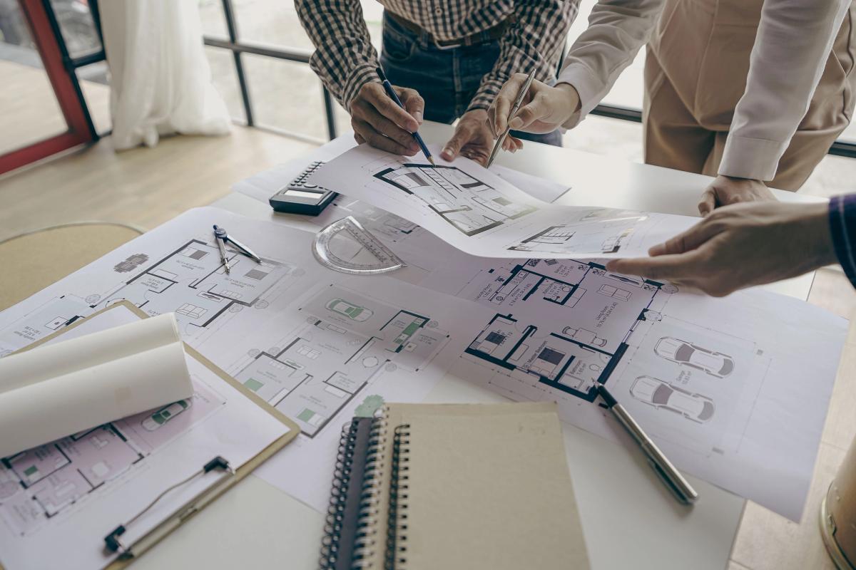 Reviewing the drawings together to agree variations and changes on a residential project.