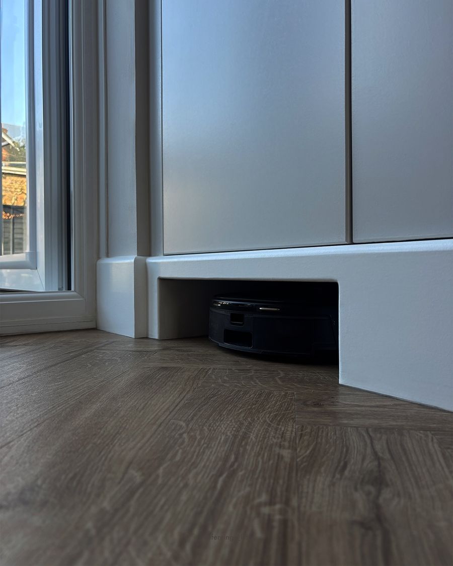 A home for the robot vacuum, built into the plinth of the new cupboards.