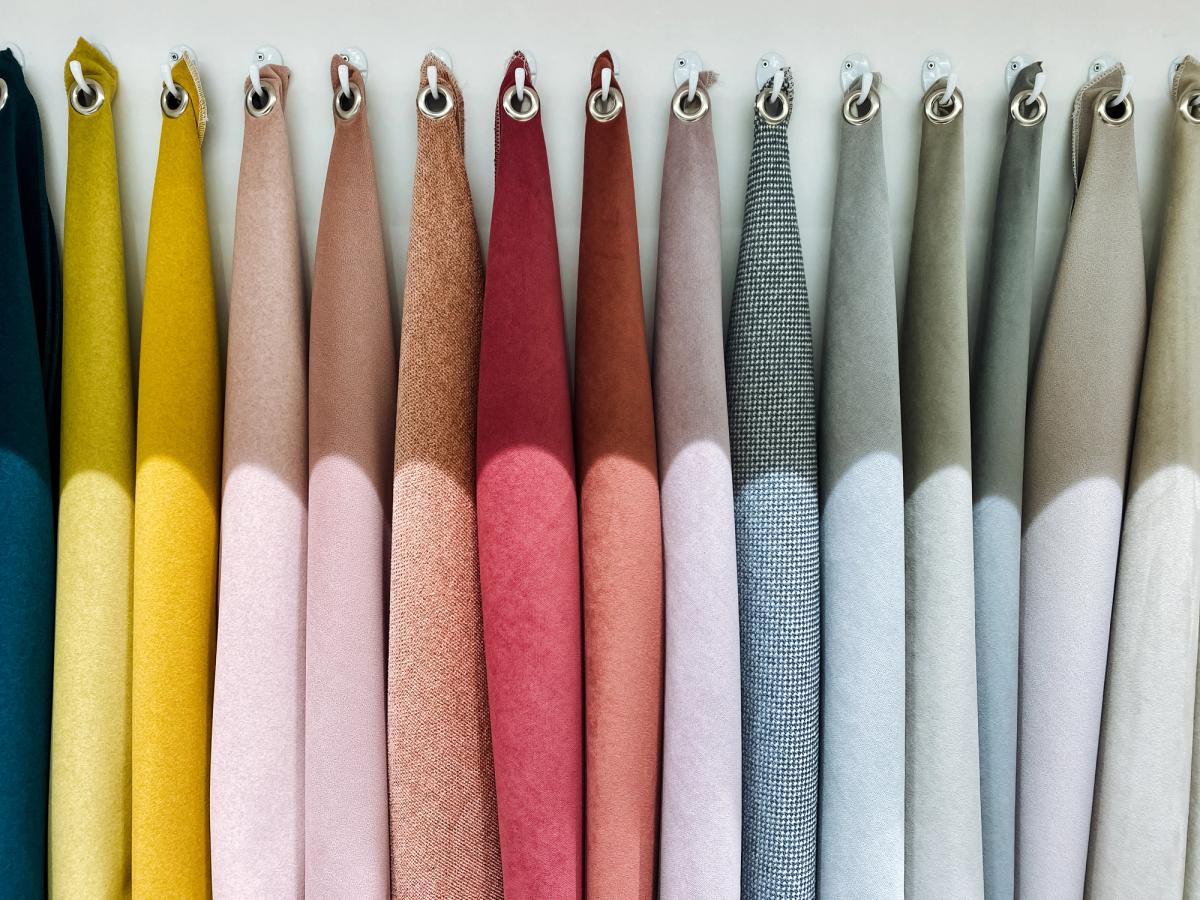 A row of velvet and woven fabric swatches in a range of colours for an interior design scheme.
