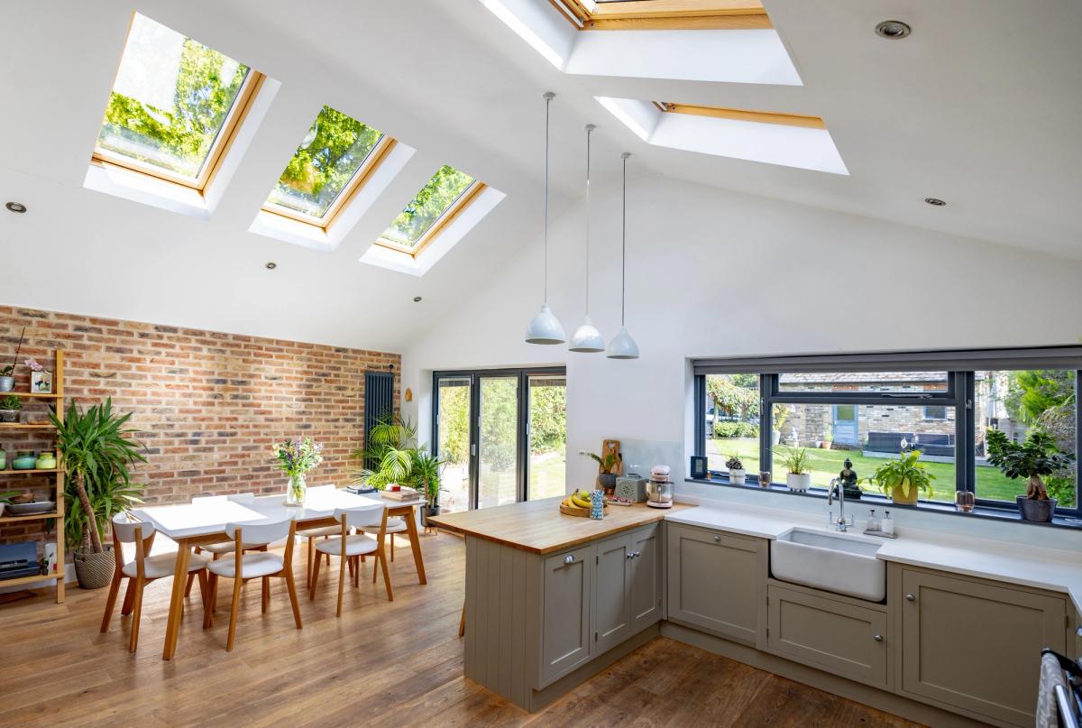 A bright open-plan kitchen extension with a vaulted ceiling, skylights and bifold doors to the garden.