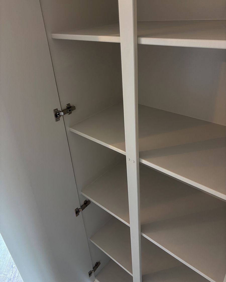 Inside the fitted cupboards: full-height adjustable shelving on soft-close hinges.
