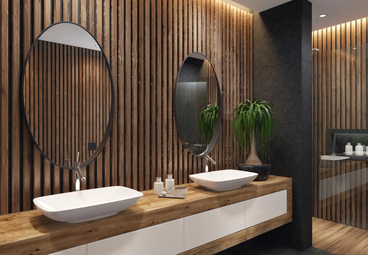 A contemporary bathroom with a timber paneling wall, twin basins and an oak vanity in a refurbished home.