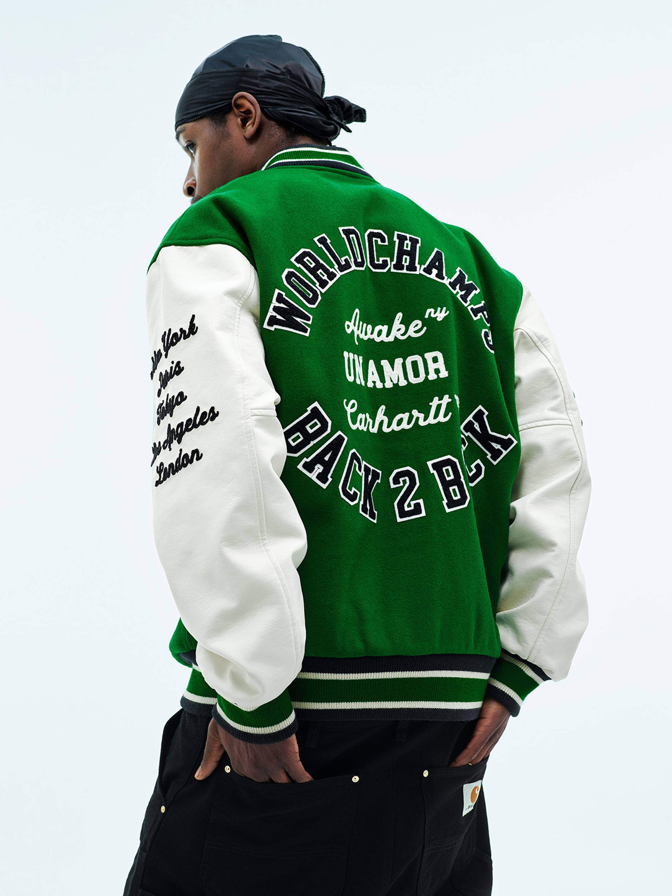 Model wearing Carhartt WIP x Awake NY Varsity Jacket in Green