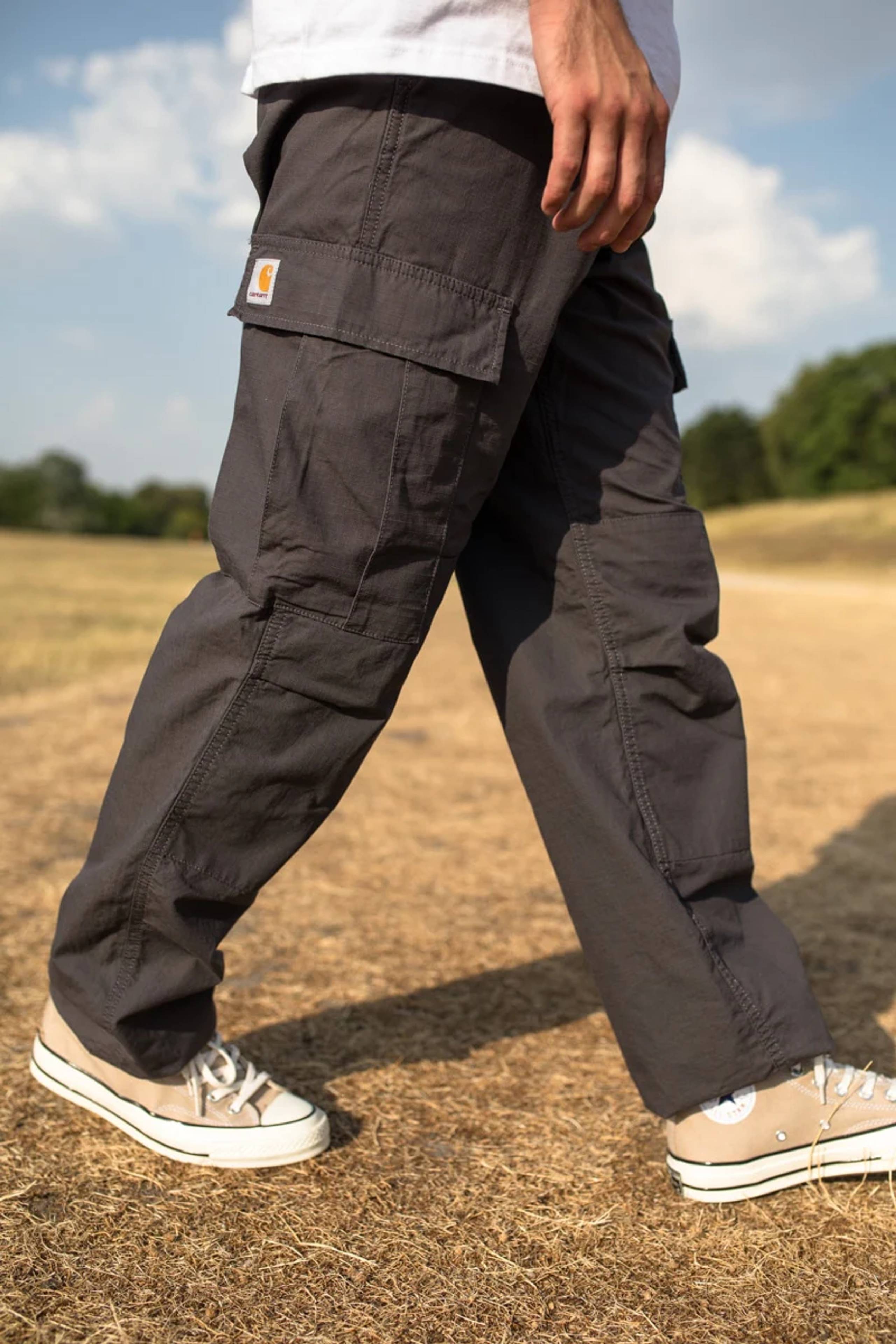 Model wearing dark grey Carhartt WIP cargo pants