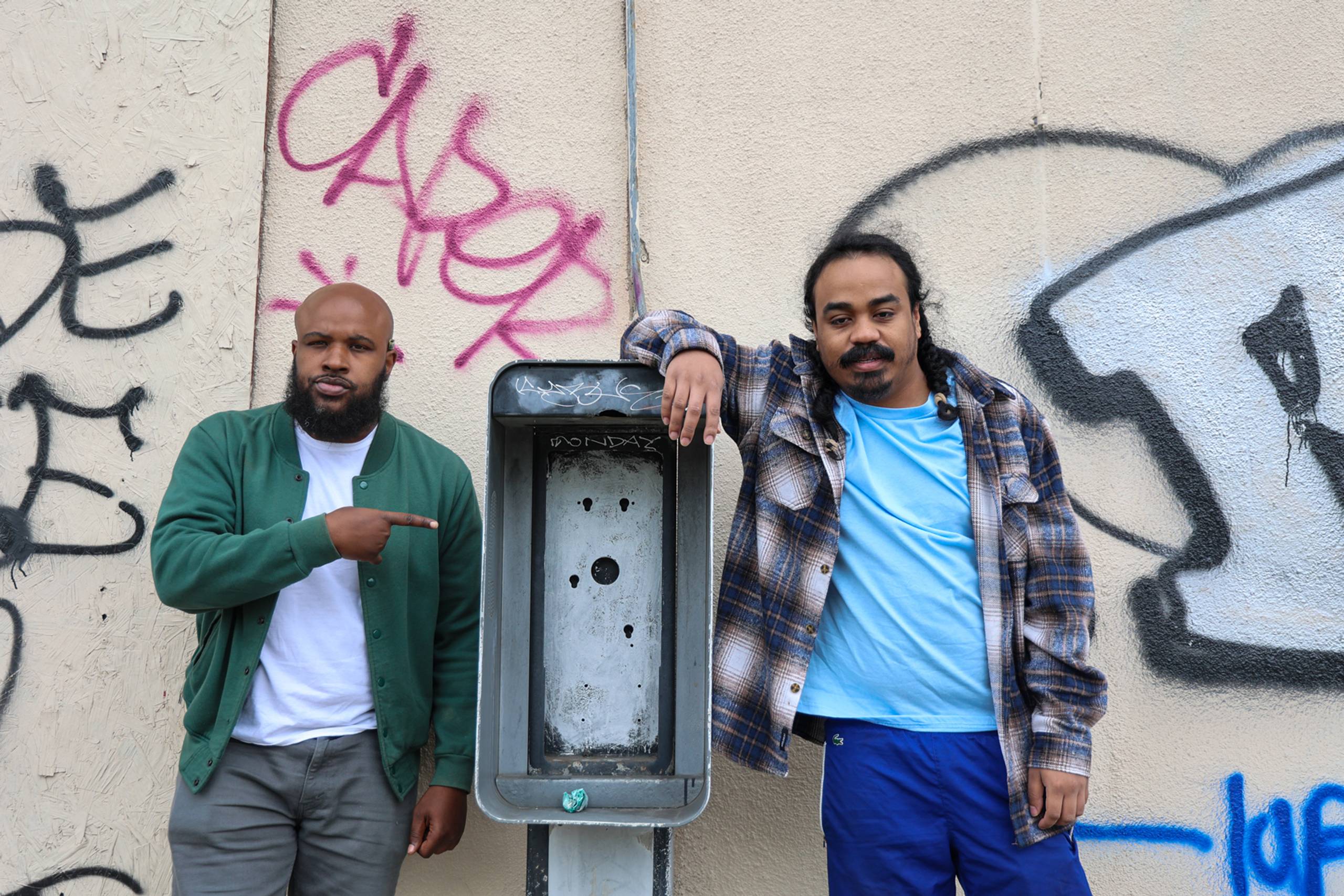 Infinity Knives posing near an old telephone booth