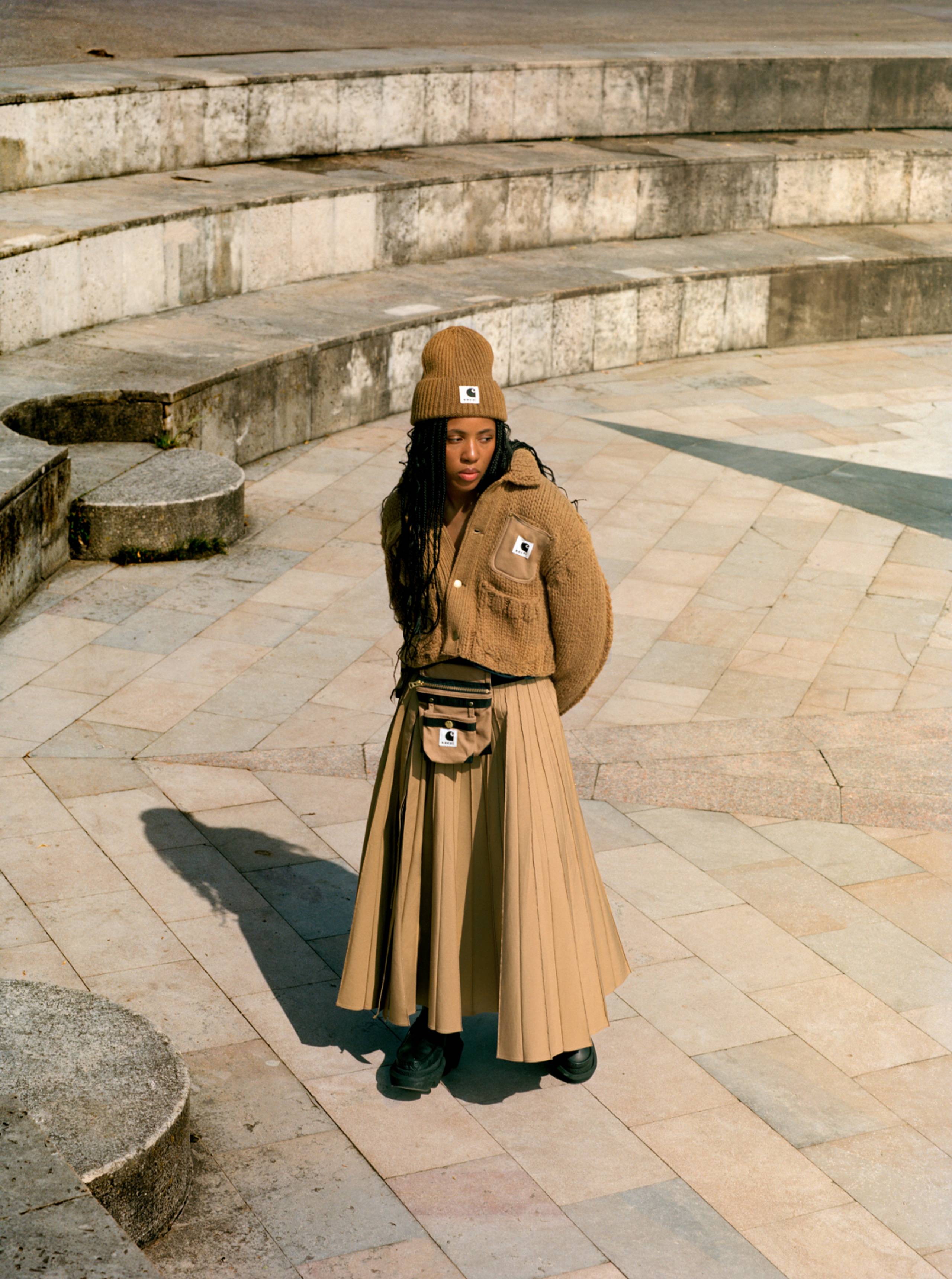 Model wearing items from the sacai x Carhartt WIP collection