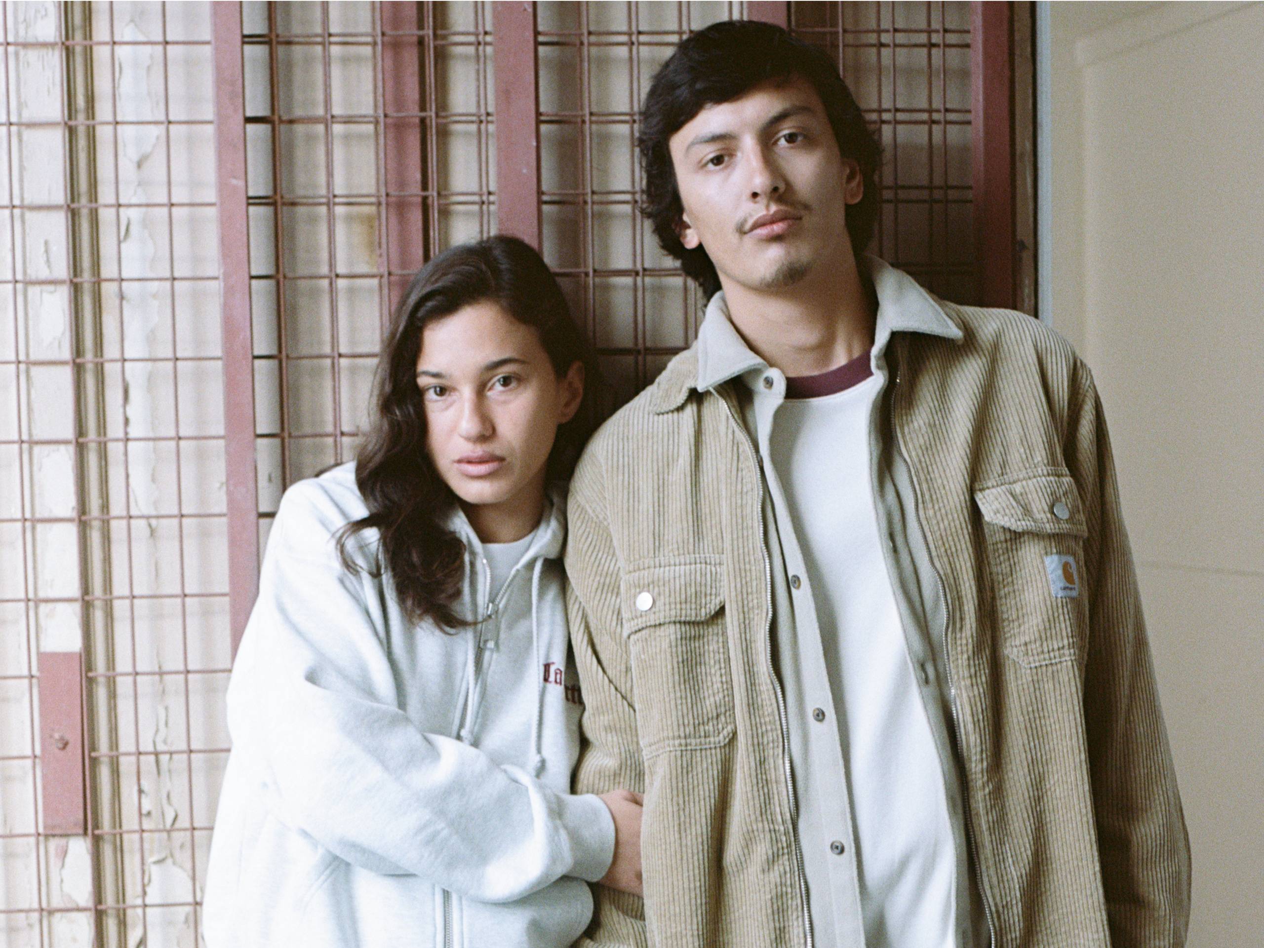Person on the left wearing zip up sweatshirt, person on the right wearing a corduroy shirt jacket