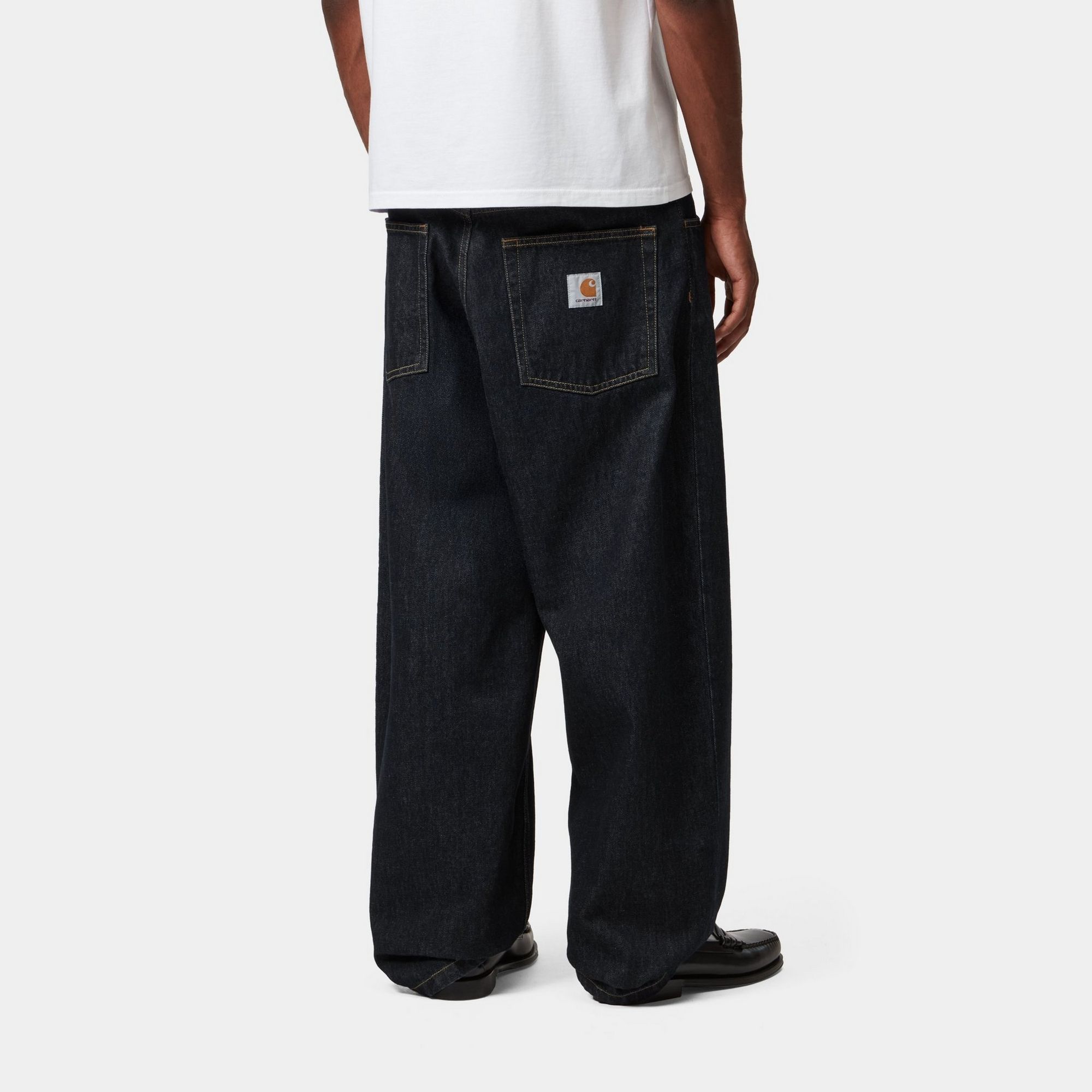 Model wearing a pair of Brandon Pants in Blue Rigid