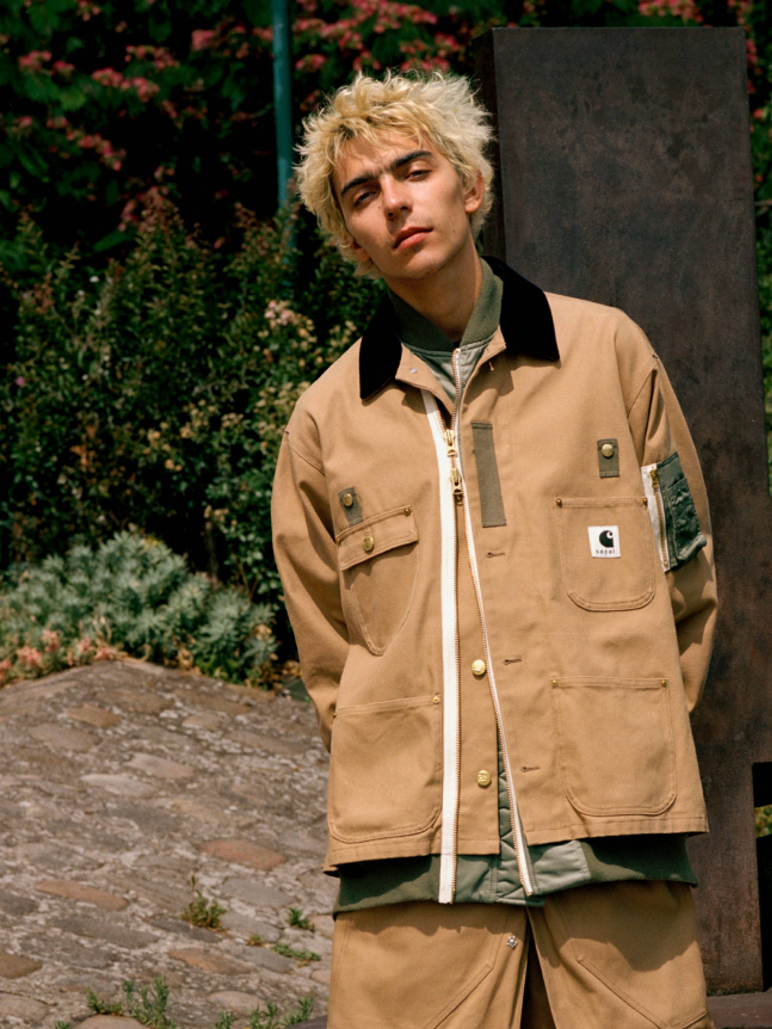 Model wearing items from the sacai x Carhartt WIP collection