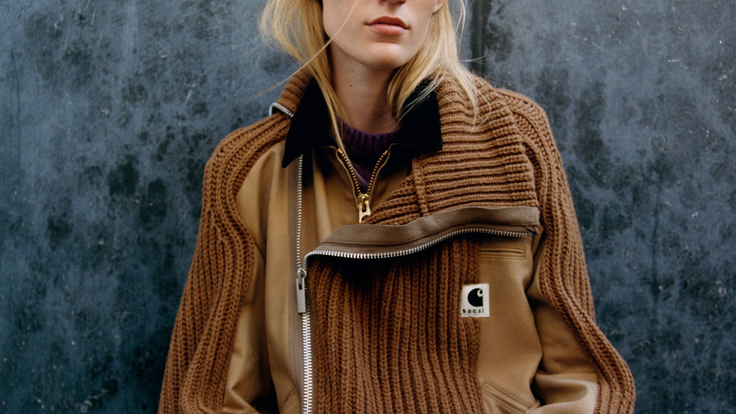 Person wearing a brown sacai x Carhartt WIP zip up sweater jacket