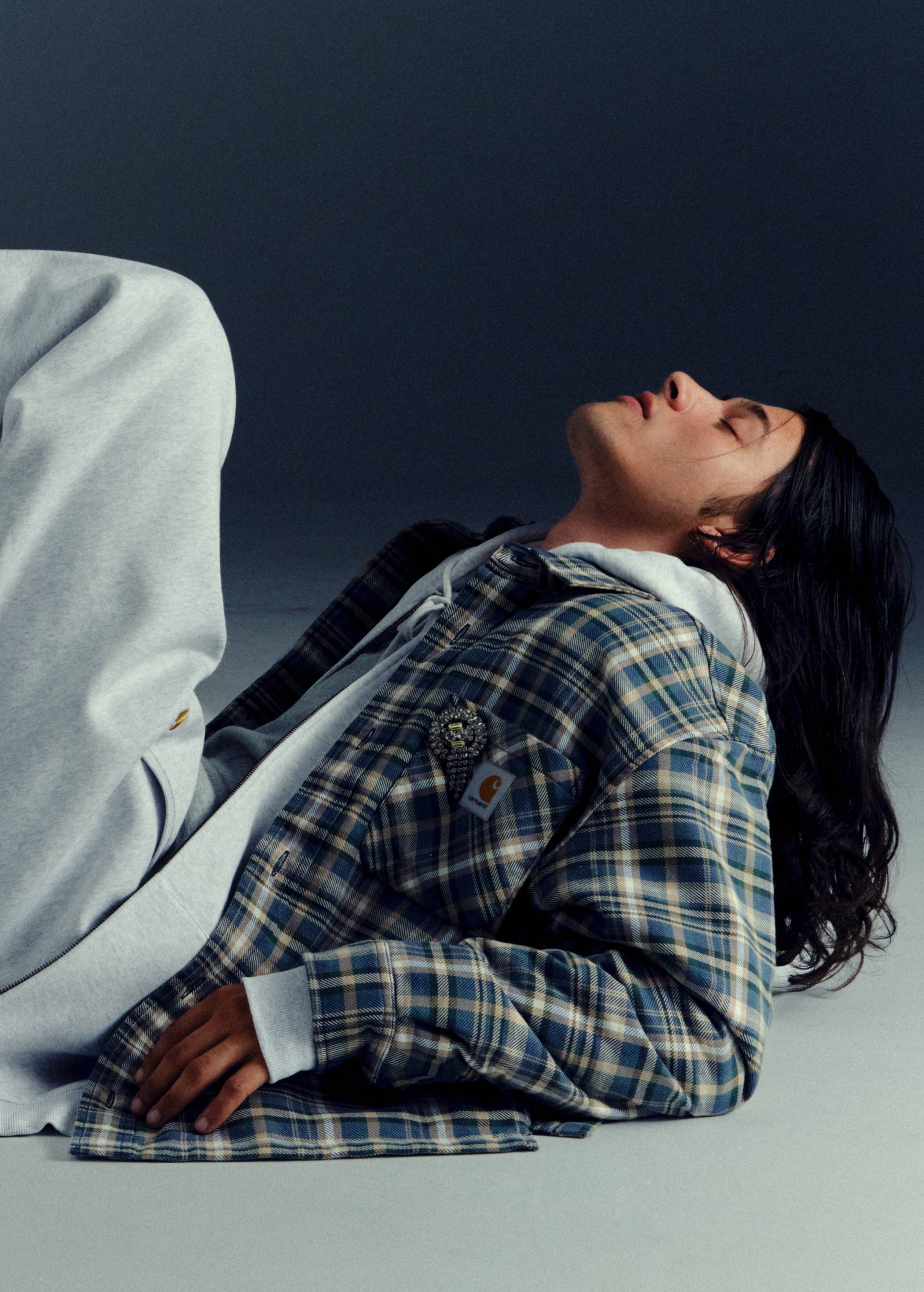Model leaned back wearing items from the Carhartt WIP Fall/Winter 2025 Icons Shoot