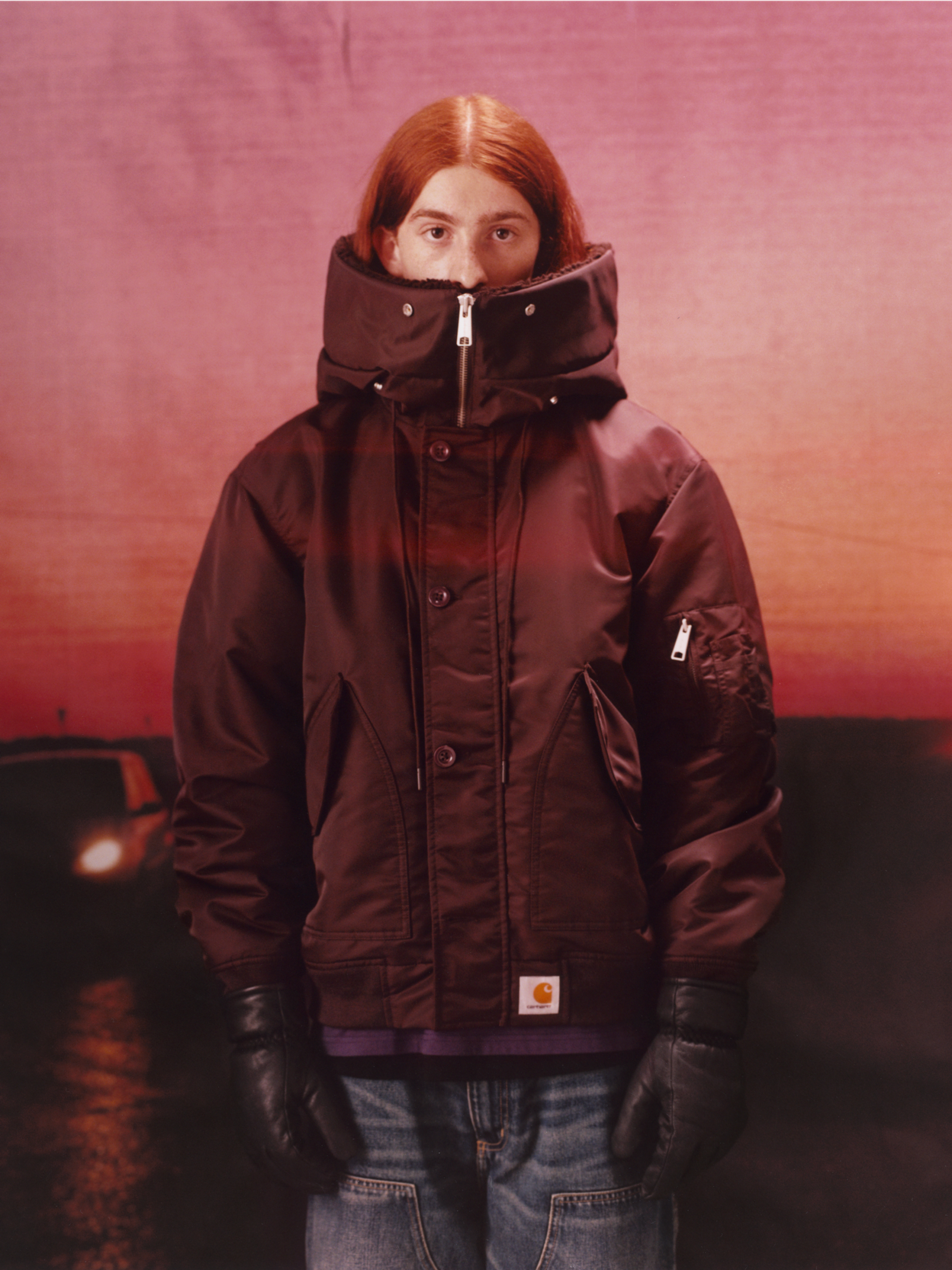 Model wearing a winter coat and gloves in the Carhartt WIP F/W25 Men's Lookbook
