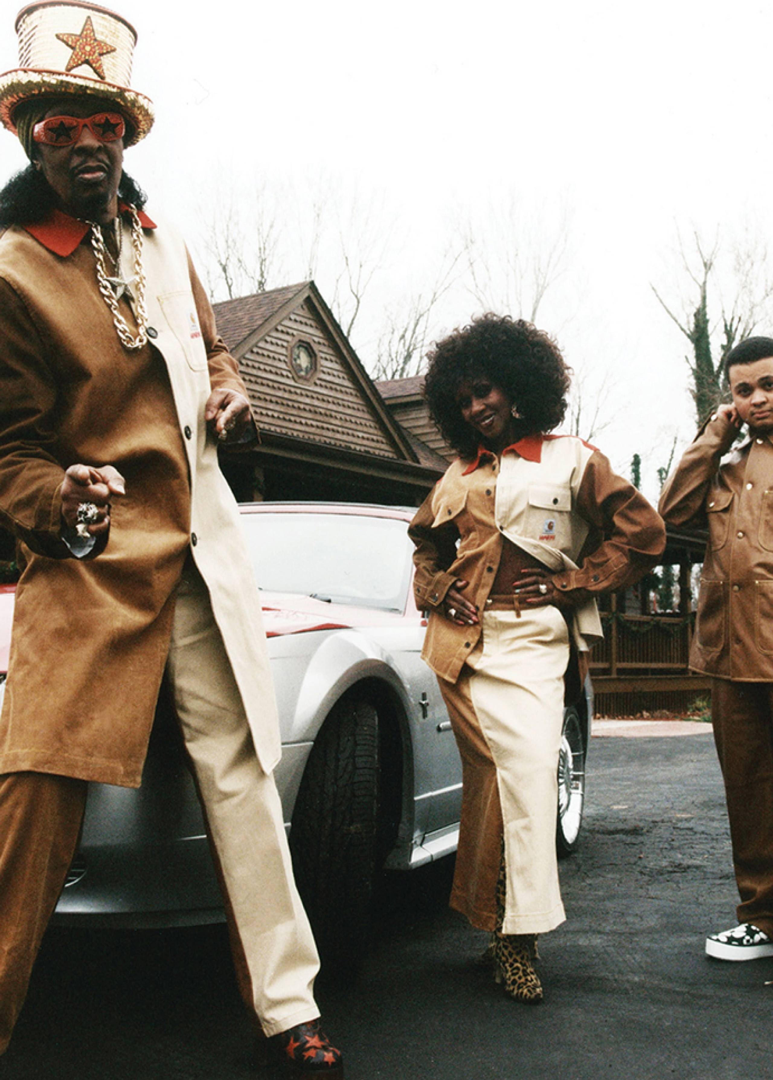 3 Models wearing MARNI x Carhartt WIP next to a car