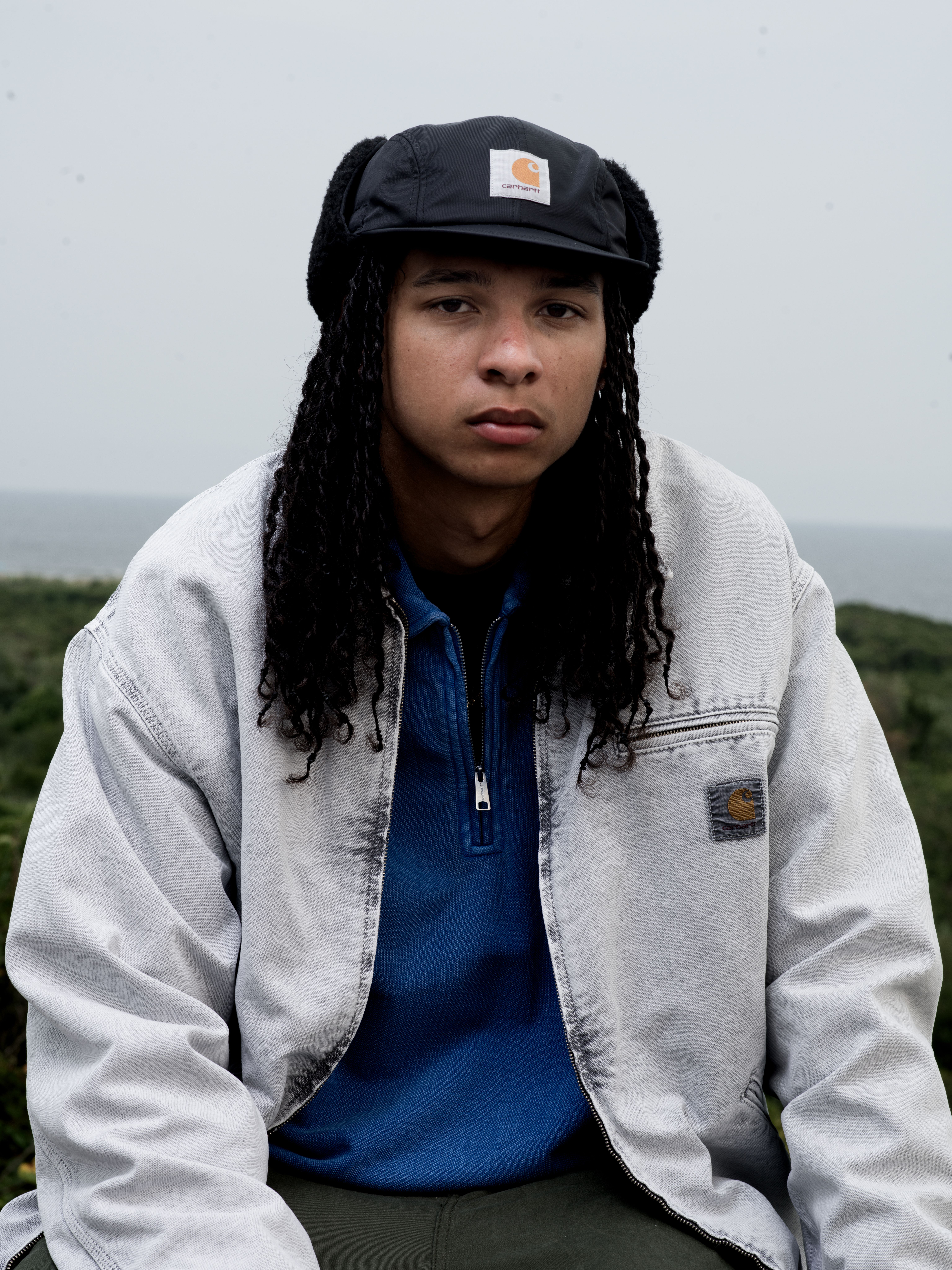 Model wearing an OG Detroit Jacket in Chalk Wash and a Pique Script Sweatshirt in Wolfsbane