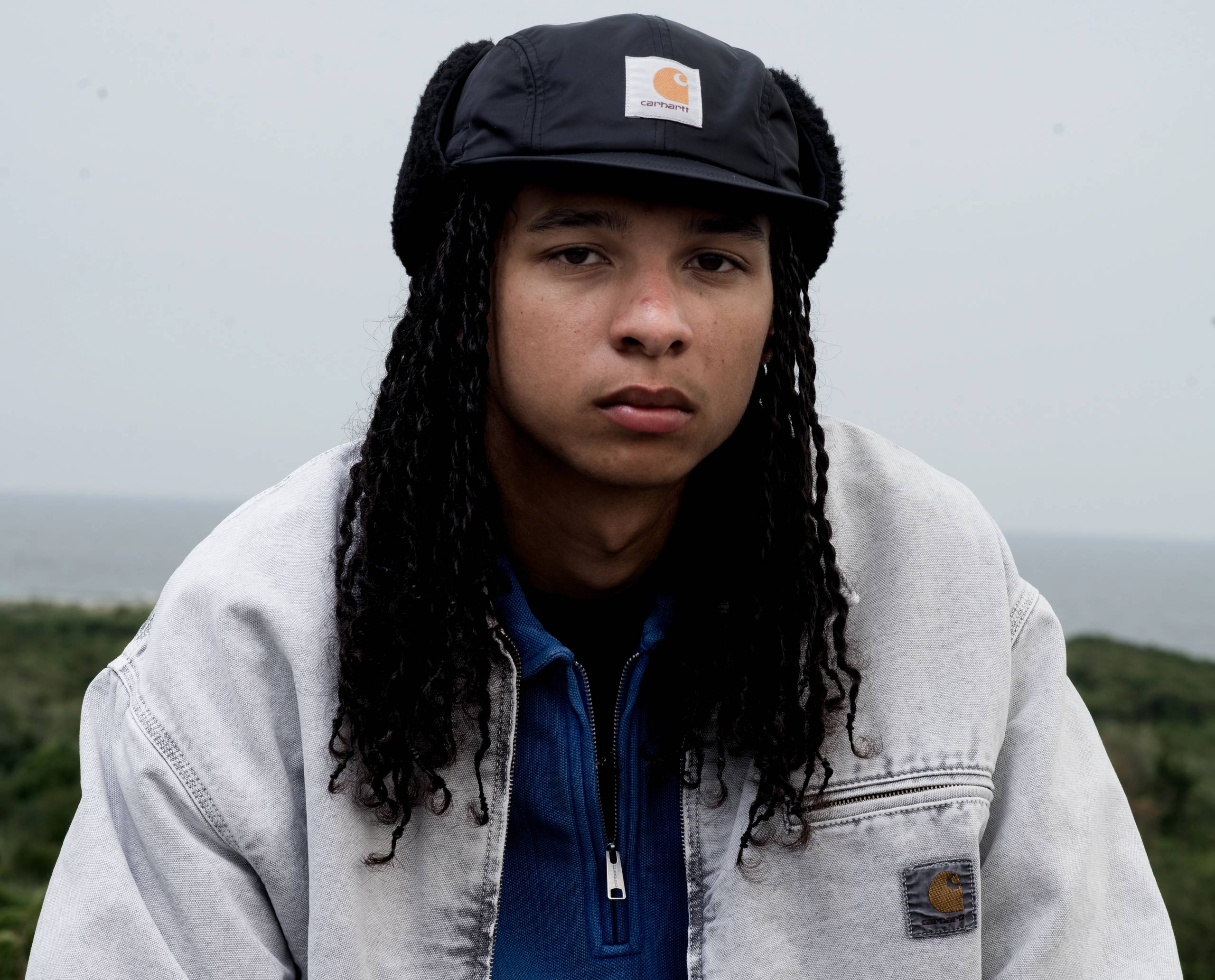 Model wearing an OG Detroit Jacket in Chalk Wash and a Pique Script Sweatshirt in Wolfsbane