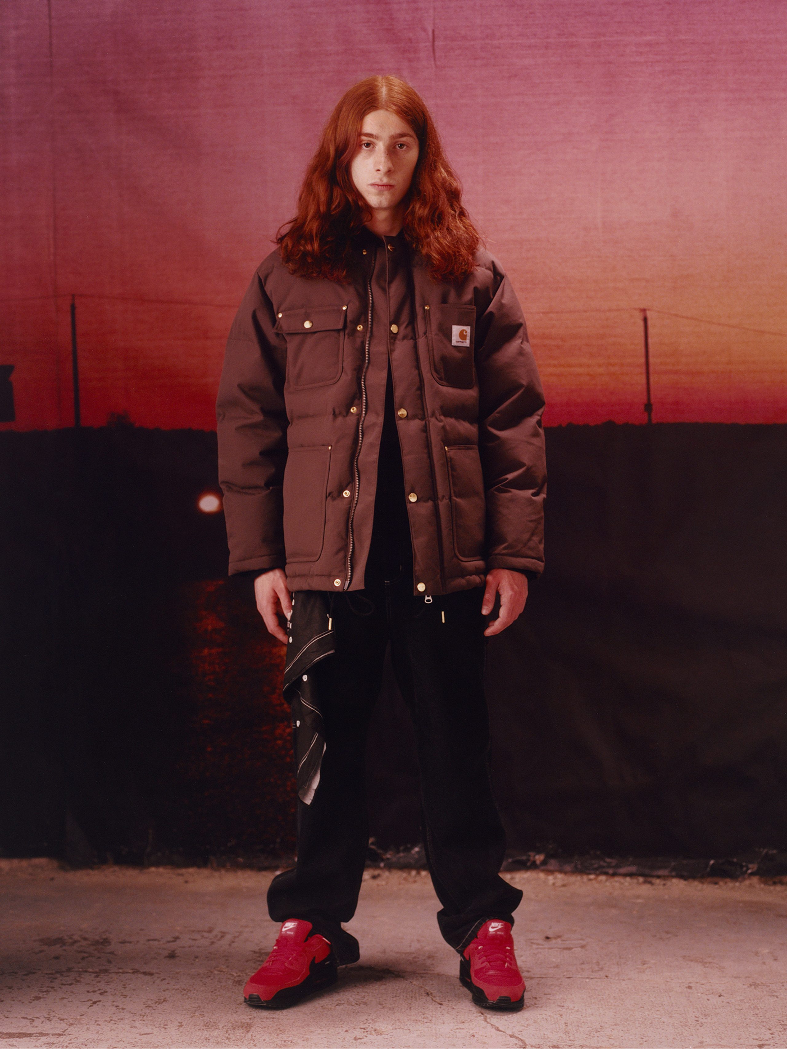 Model wearing a winter coat in the Carhartt WIP F/W25 Men's Lookbook
