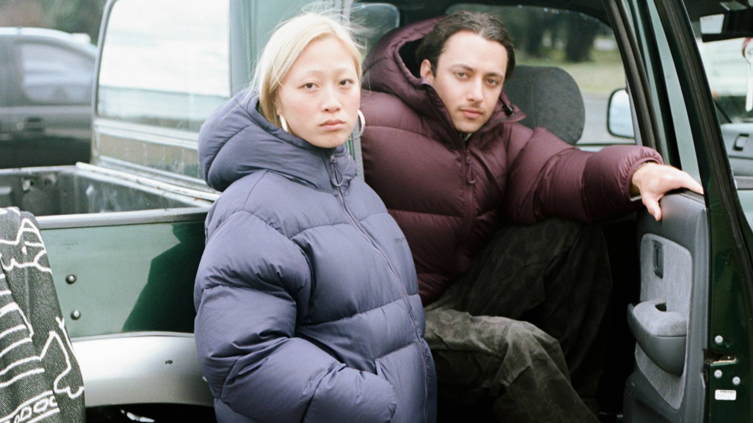 Models wearing a Toronto Jacket sitting in a car