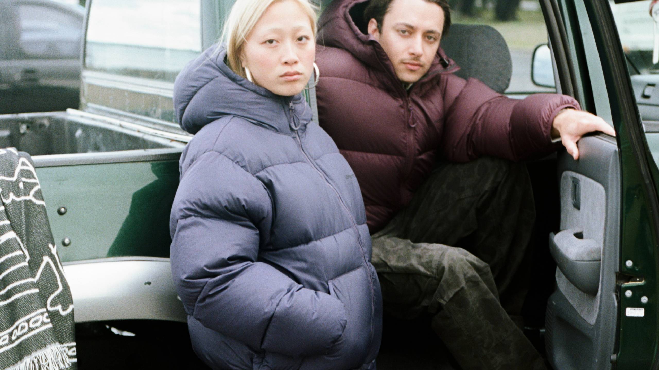 Models wearing a Toronto Jacket sitting in a car