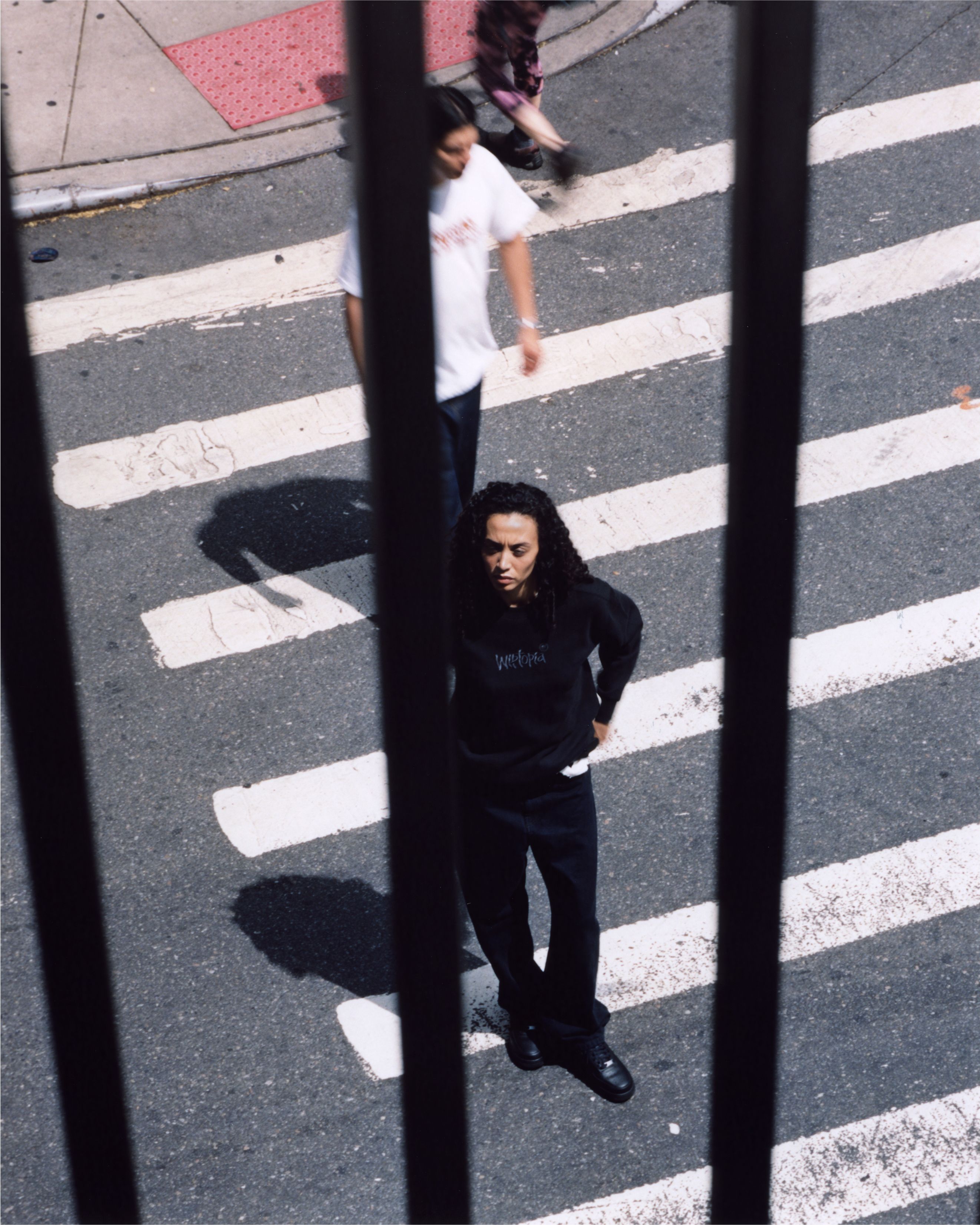 Model standing in the street wearing items from the Carhartt WIP Wiptopia Collection