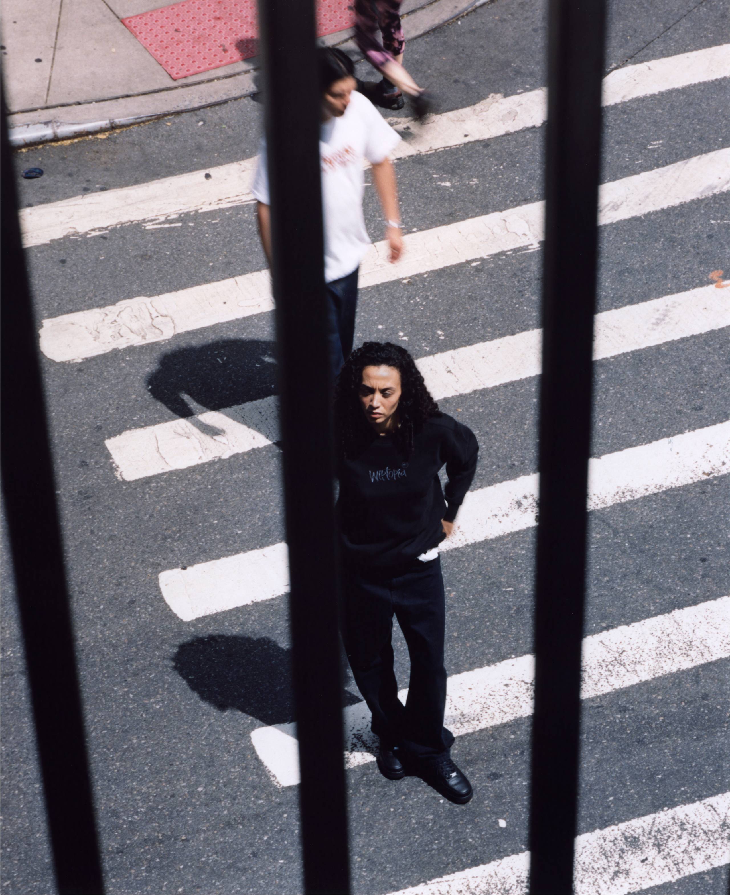 Model standing in the street wearing items from the Carhartt WIP Wiptopia Collection