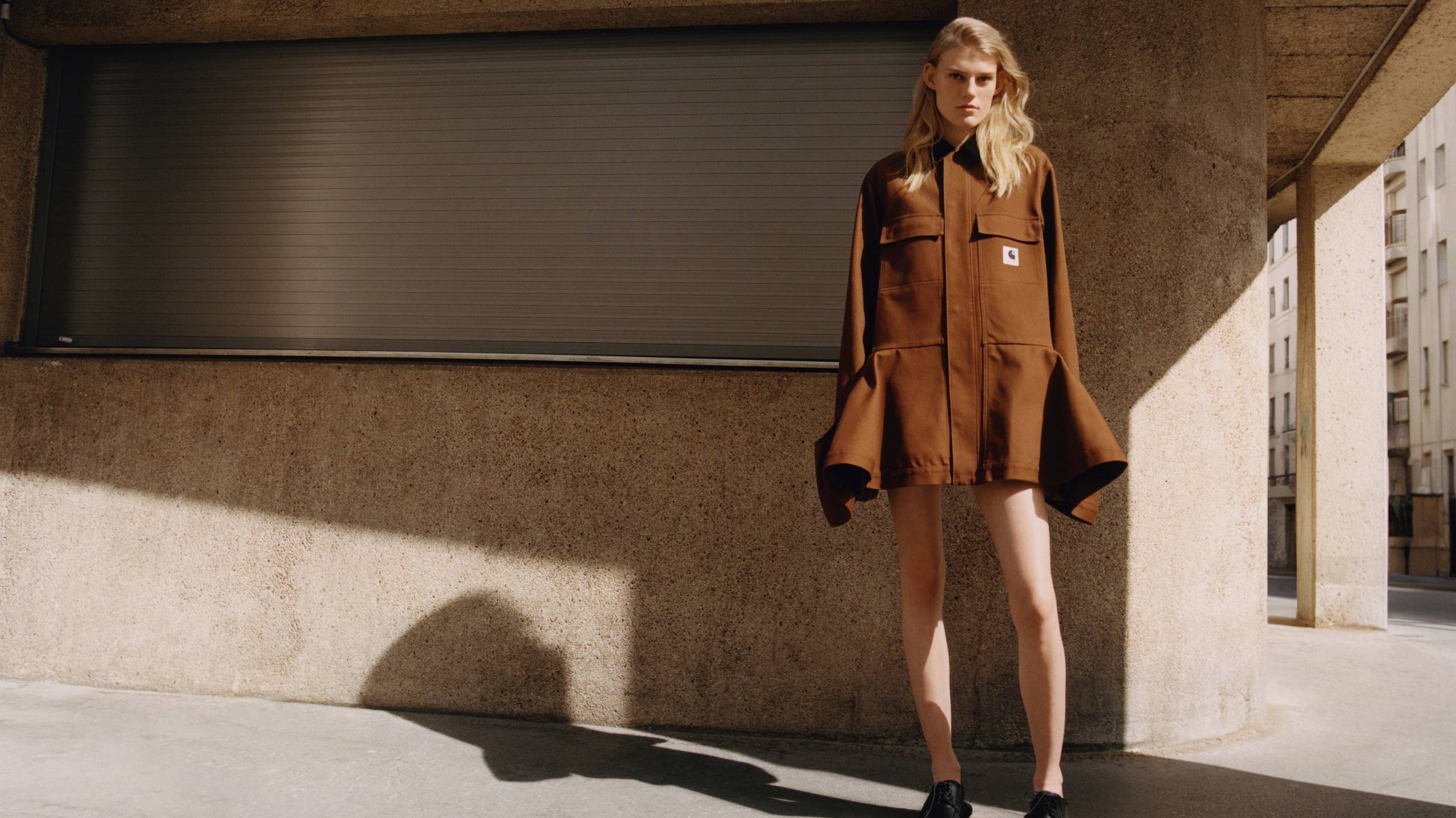 Model wearing the sacai x Carhartt WIP Women's Duck Bonding Dress Coat