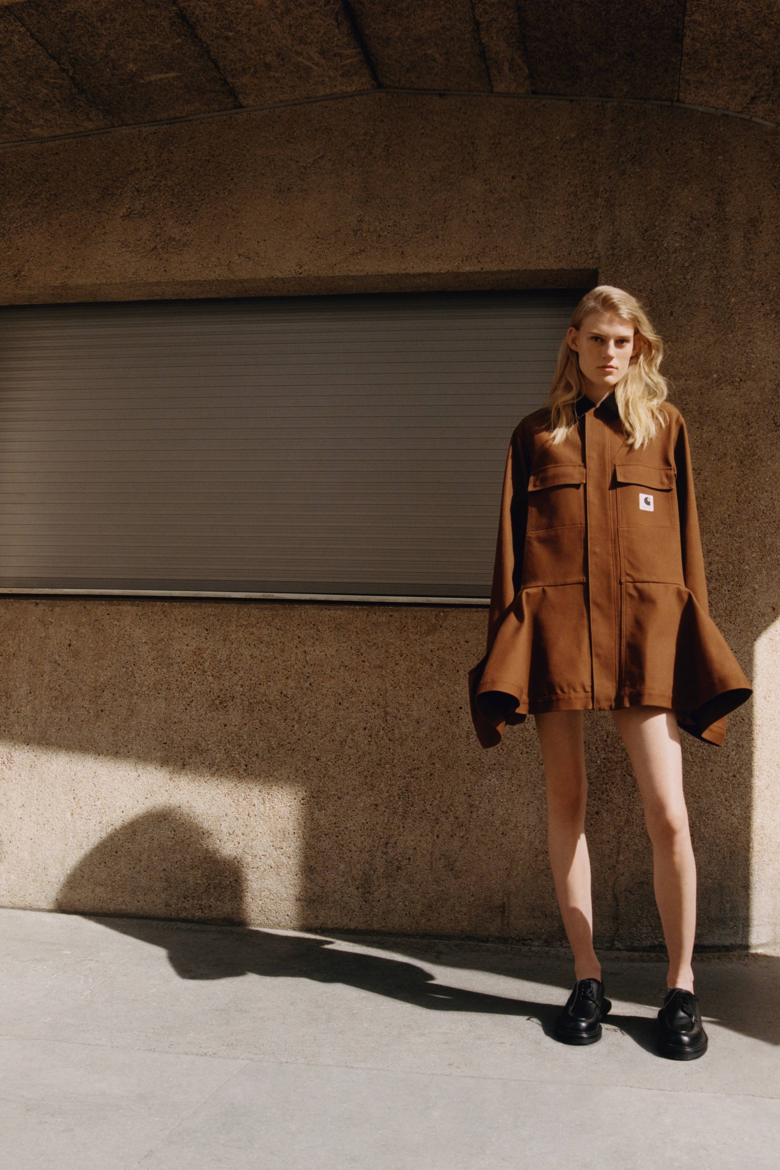 person wearing the sacai x Carhartt WIP Women's Duck Bonding Dress Coat