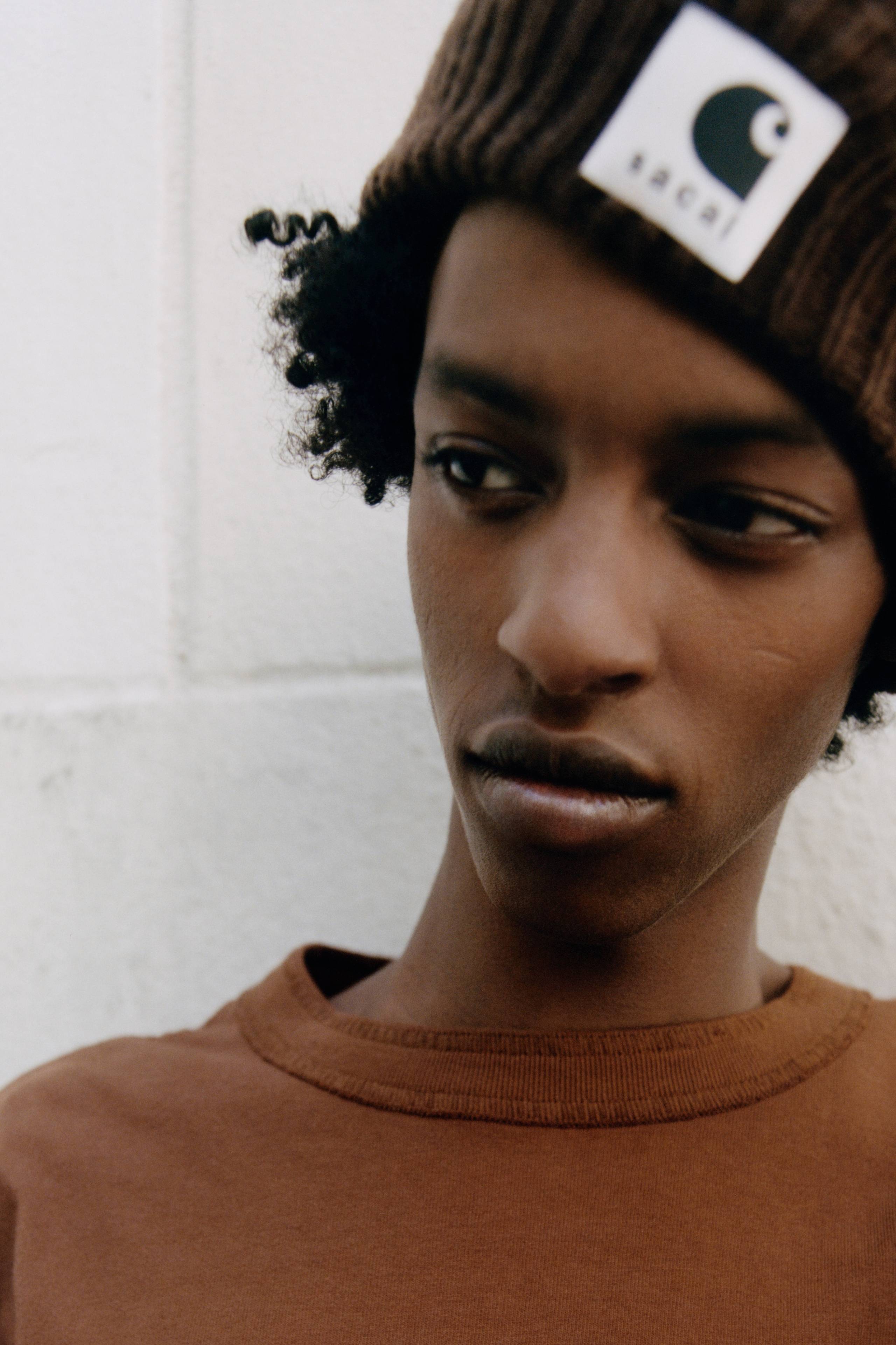 person wearing a sacai x carhartt WIP beanie and longsleeve shirt