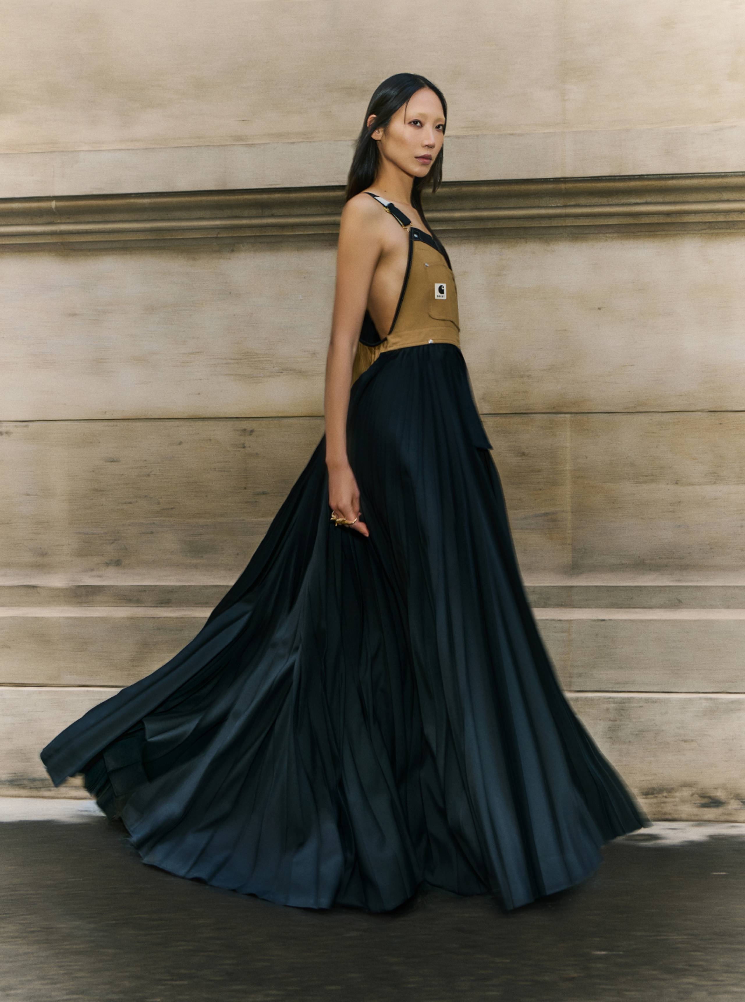 Model wearing a Dress from sacai x Carhartt WIP collab