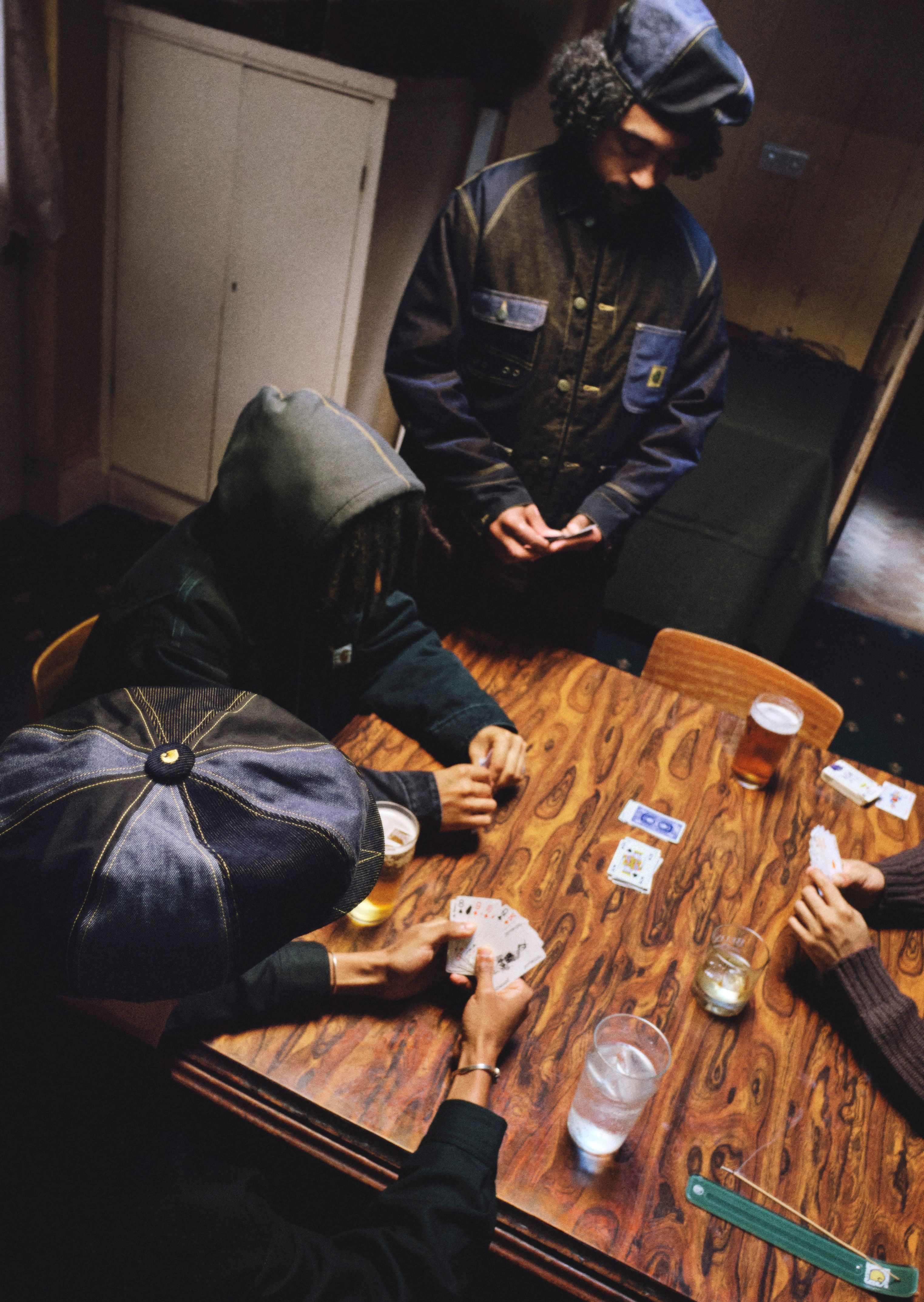 People playing card games at a table in Nicholas Daley x Carhartt WIP Campaign