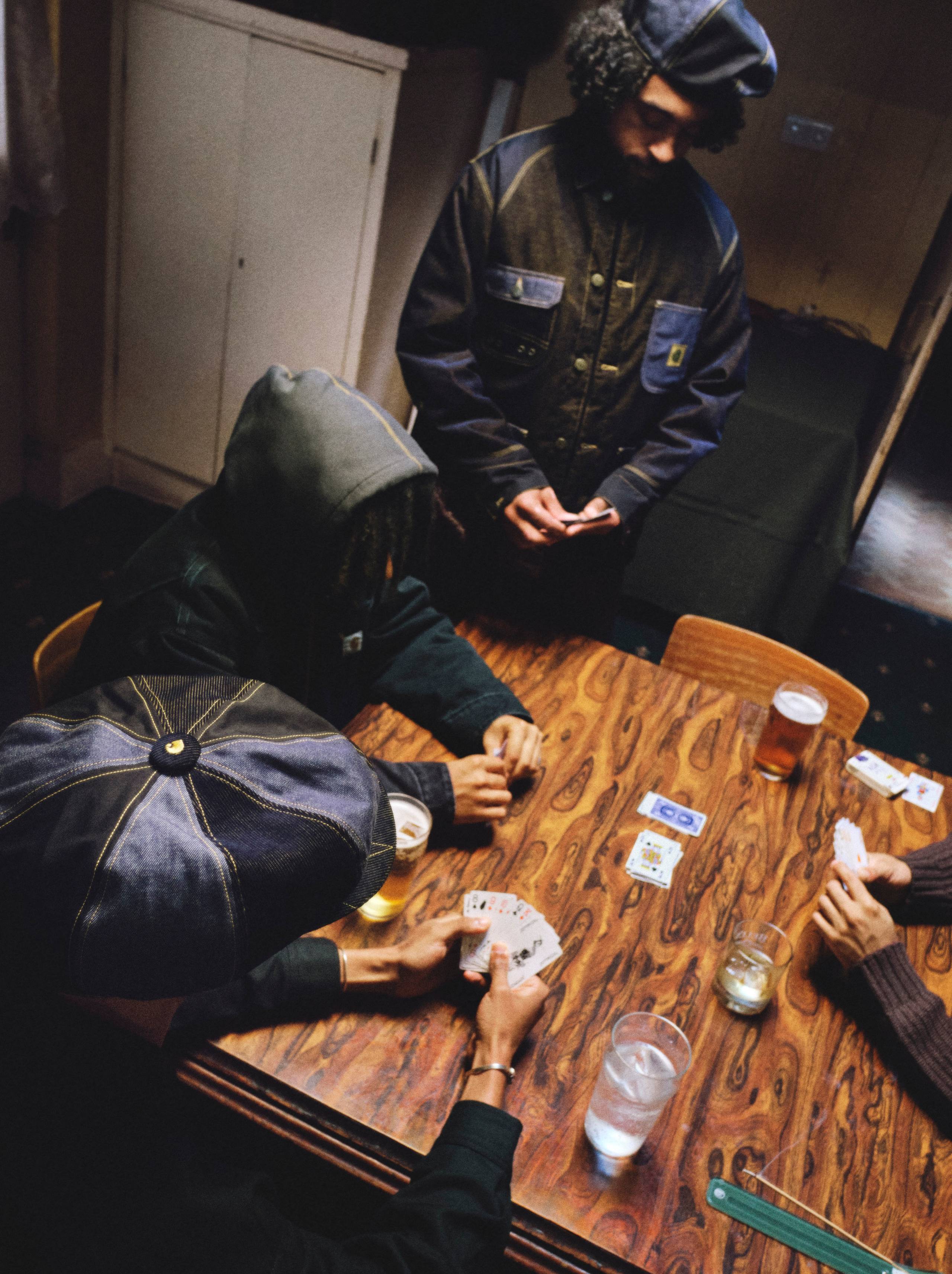 People playing card games at a table in Nicholas Daley x Carhartt WIP Campaign