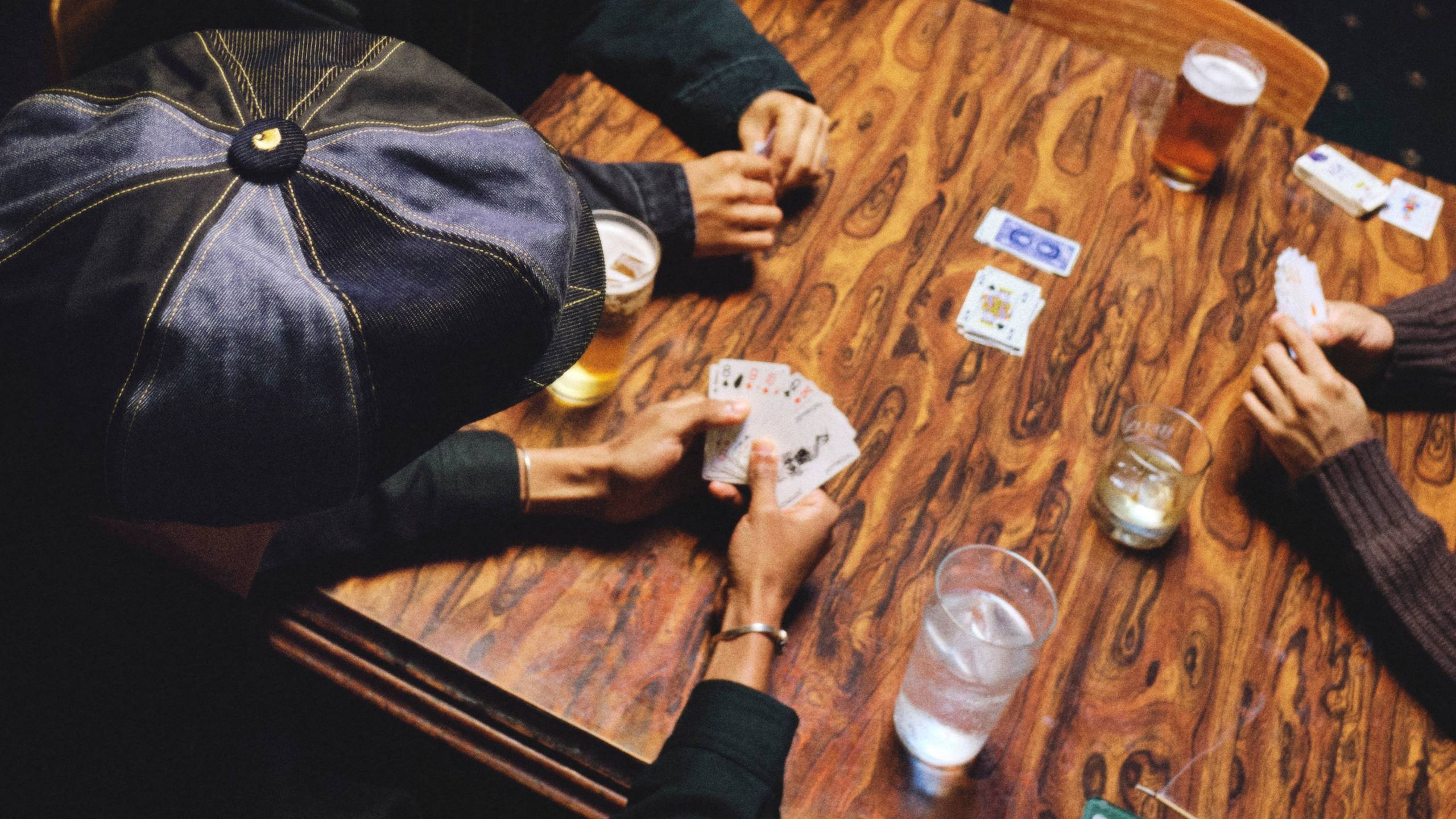 People playing card games at a table in Nicholas Daley x Carhartt WIP Campaign