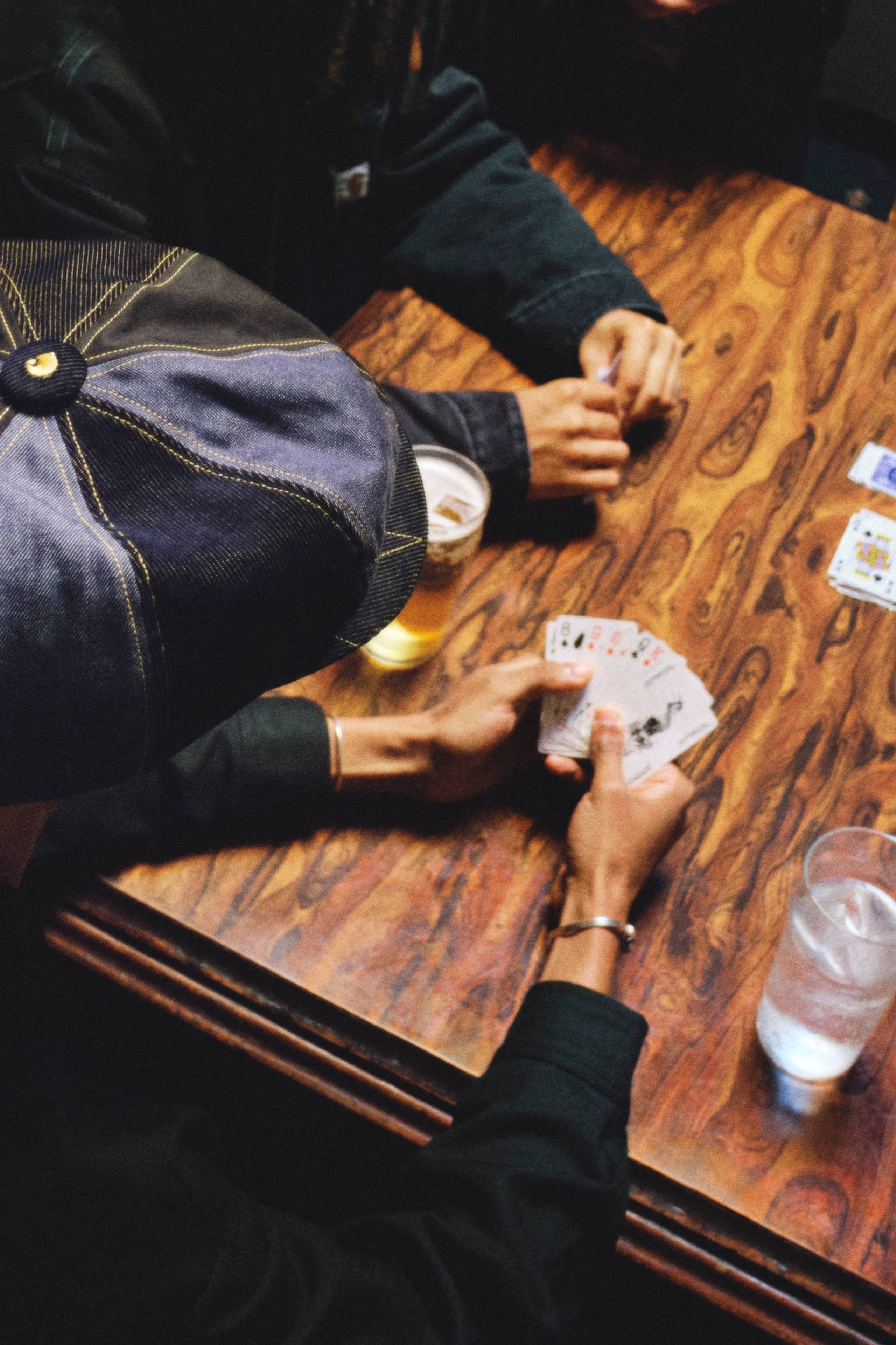 People playing card games at a table in Nicholas Daley x Carhartt WIP Campaign