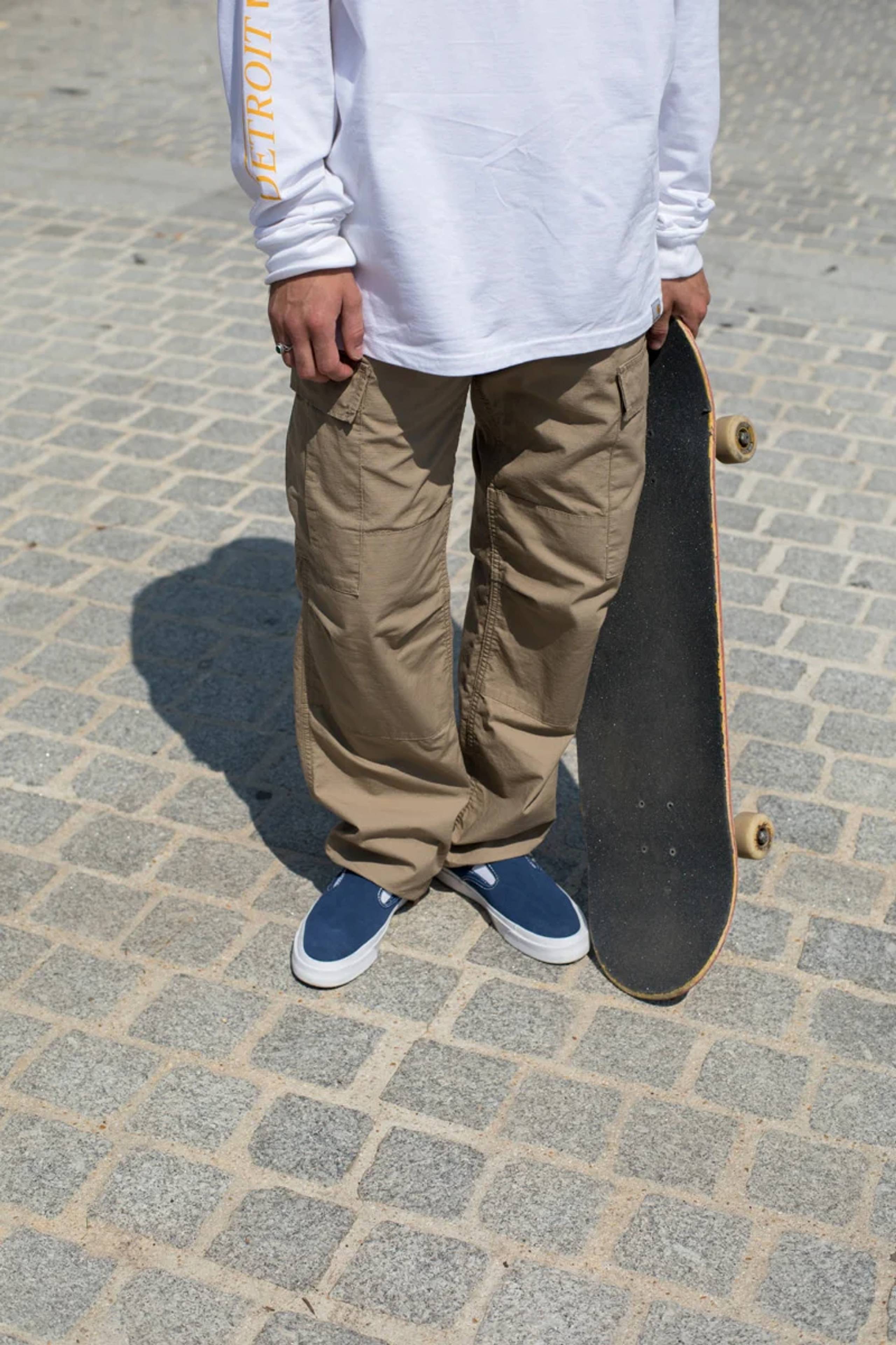 Model wearing tan Carhartt WIP cargo pants