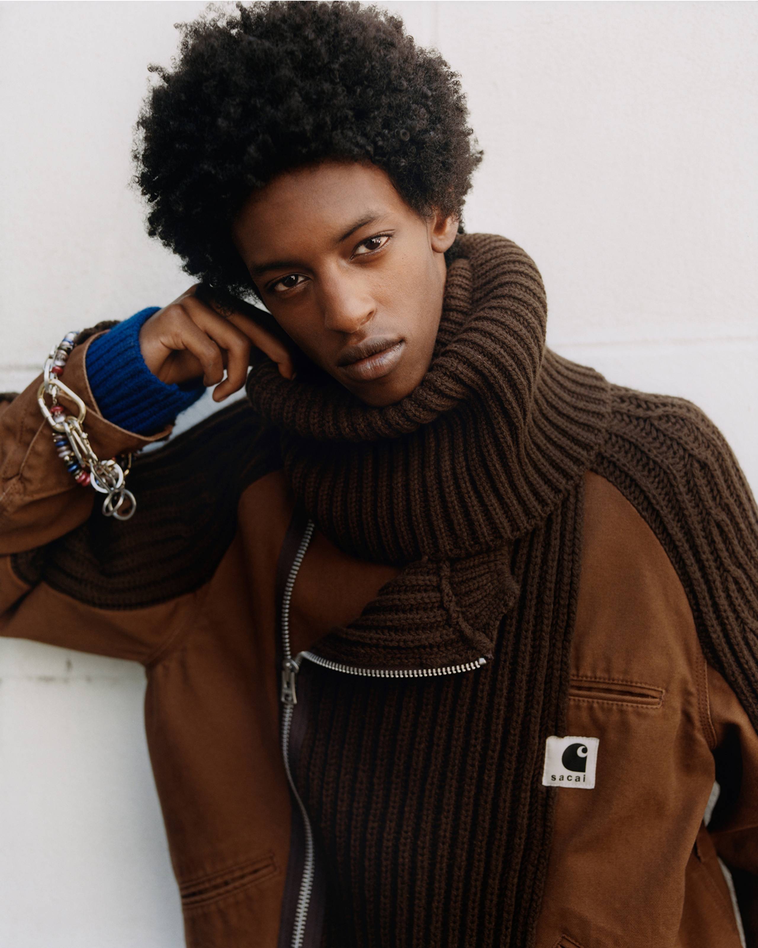 Person wearing a brown sacai x Carhartt WIP zip up jacket