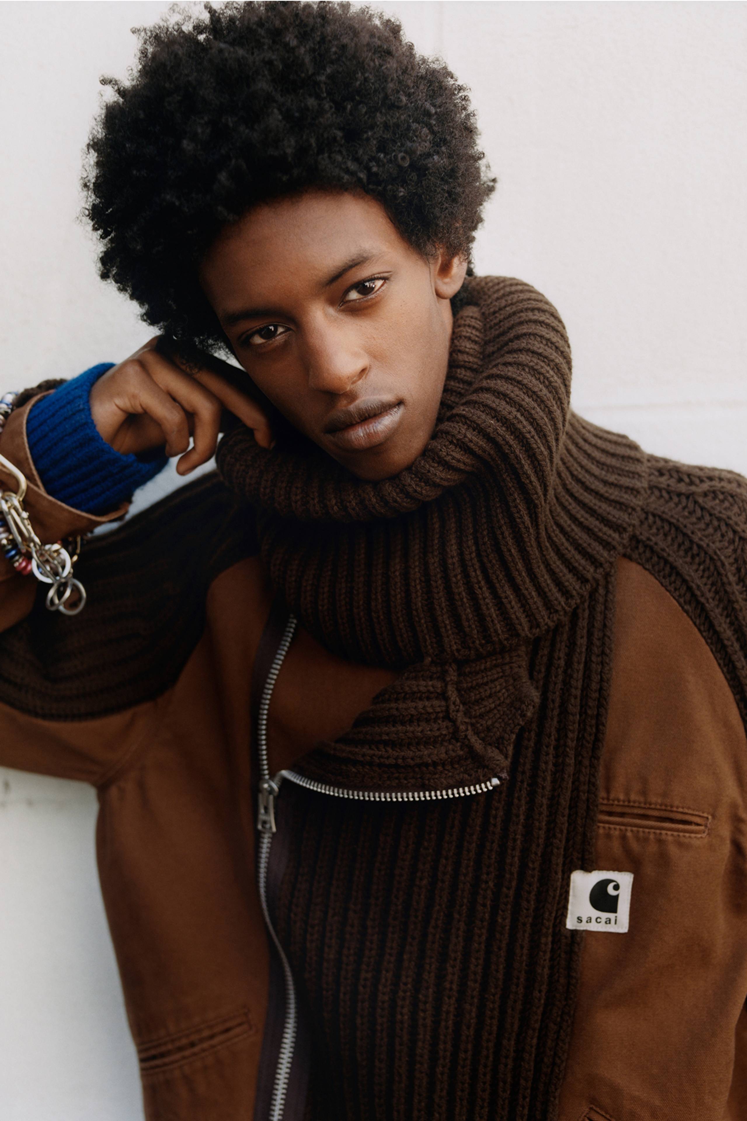 Person wearing a brown sacai x Carhartt WIP zip up jacket
