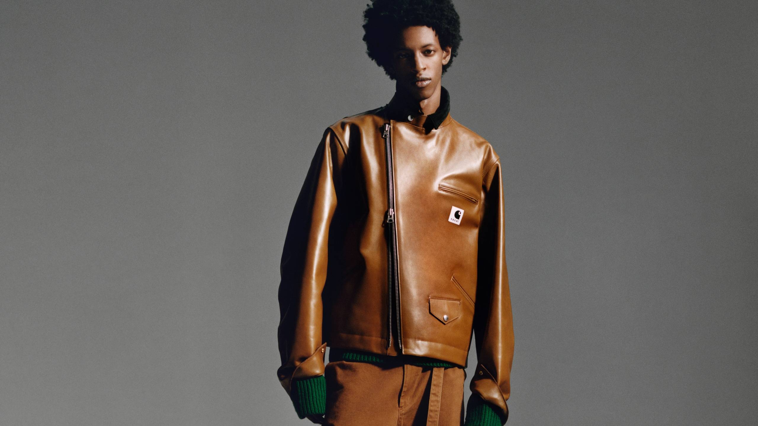 Model wearing items from the sacai x Carhartt WIP Fall/Winter 2025 Collaboration