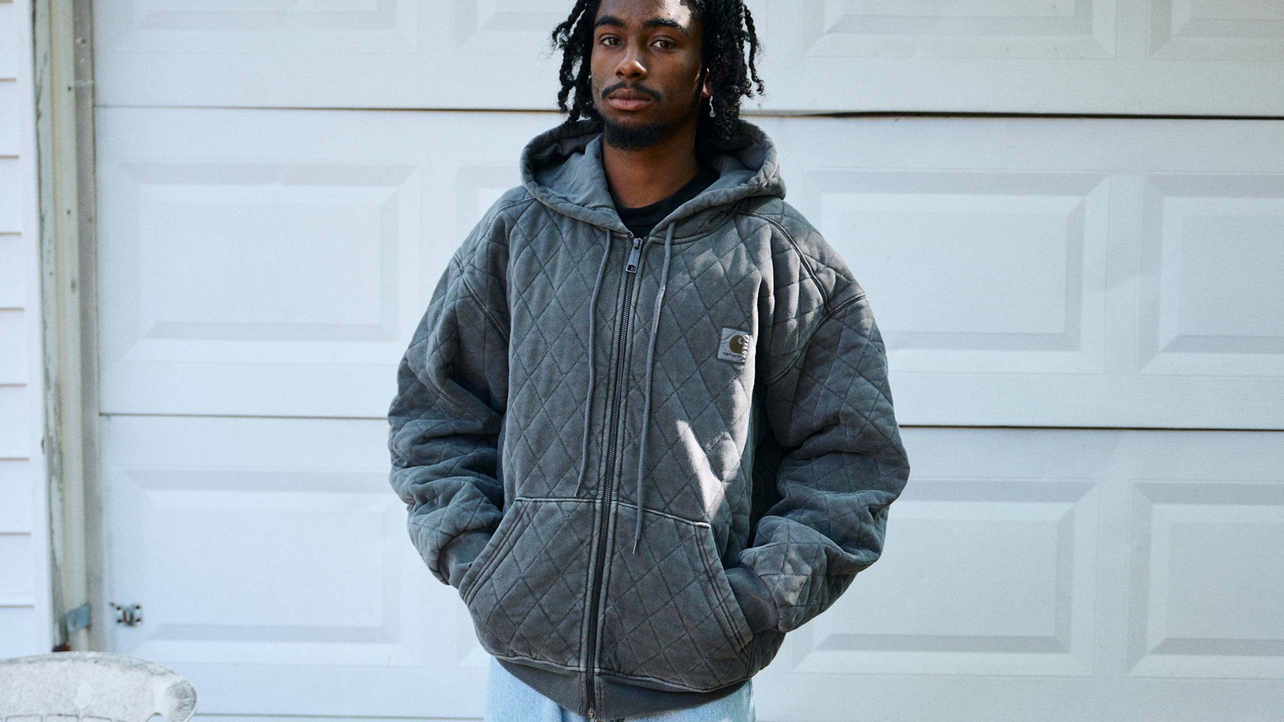 Model wearing a Hooded Vista Quilted Sweat Jacket in Black (Garment Dyed)