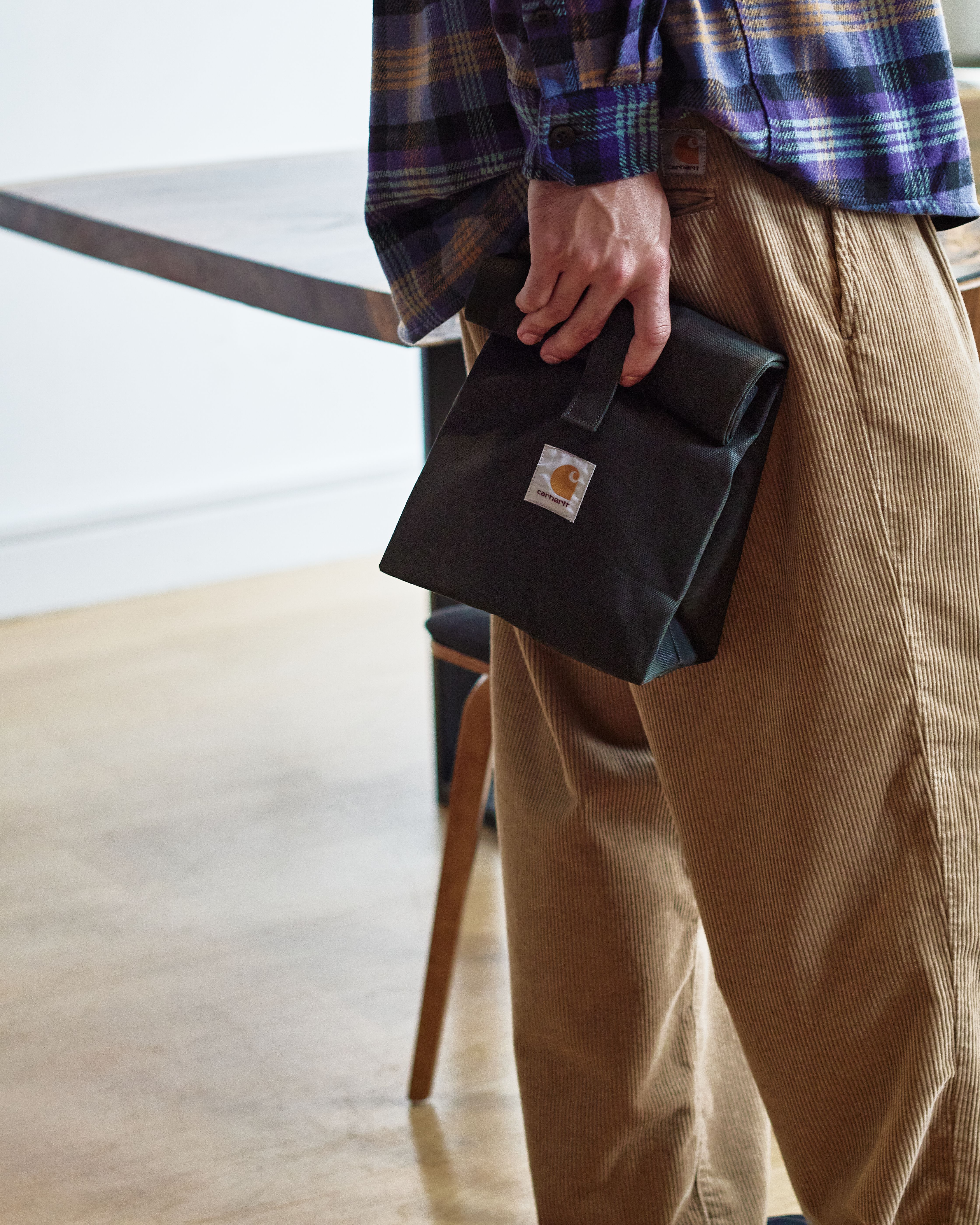 Model holding a lunch bag in black