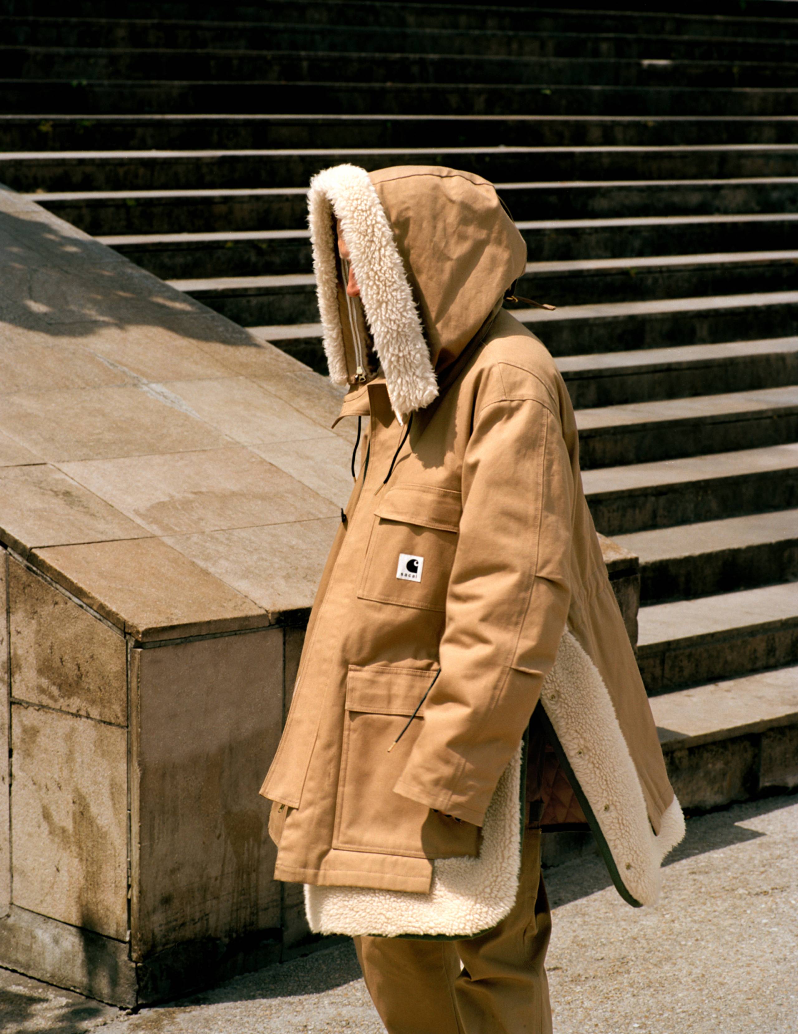 Model wearing a Parka from the sacai x Carhartt WIP collab