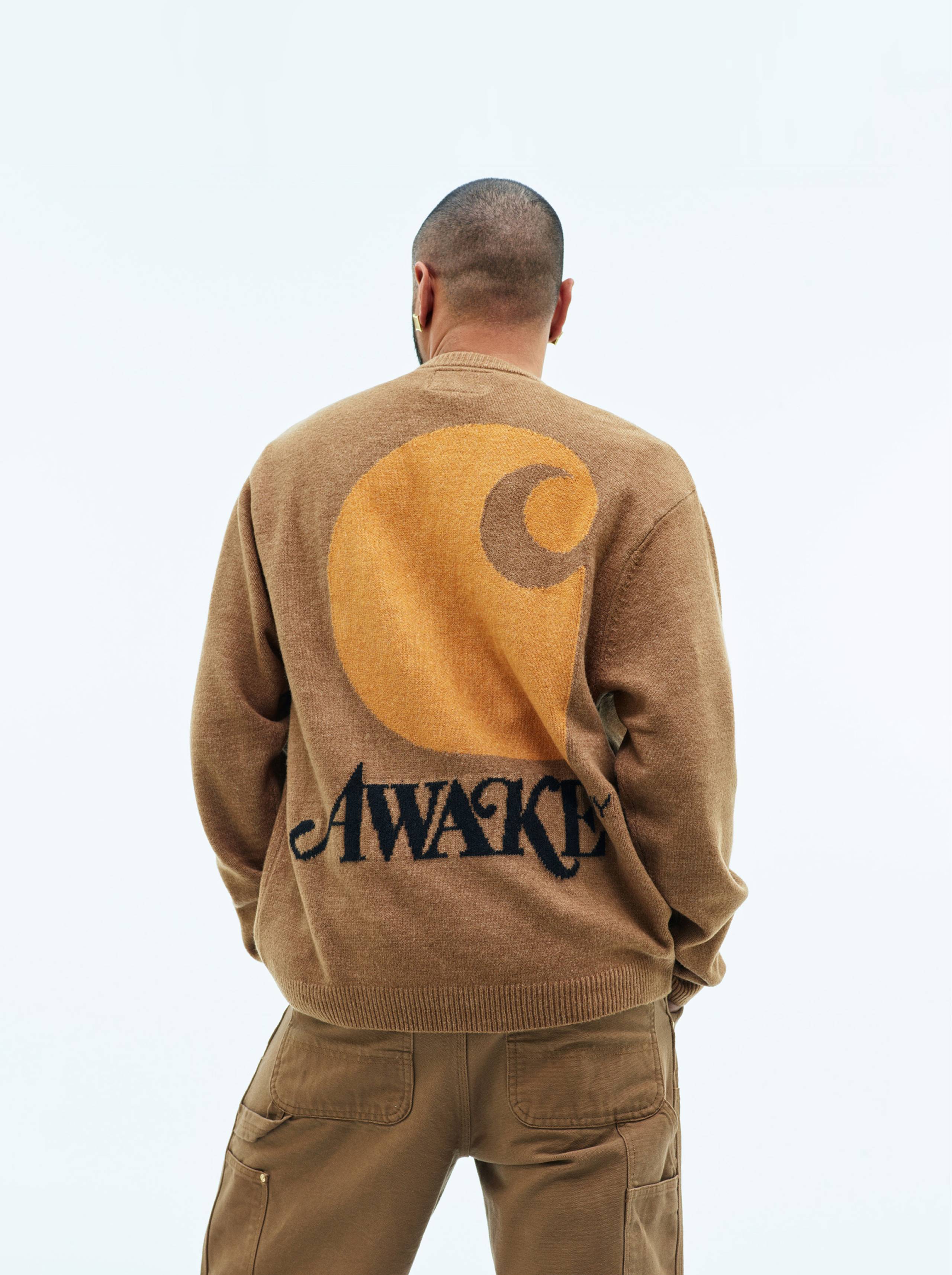 Model wearing Carhartt WIP x Awake NY cardigan in Hamilton Brown