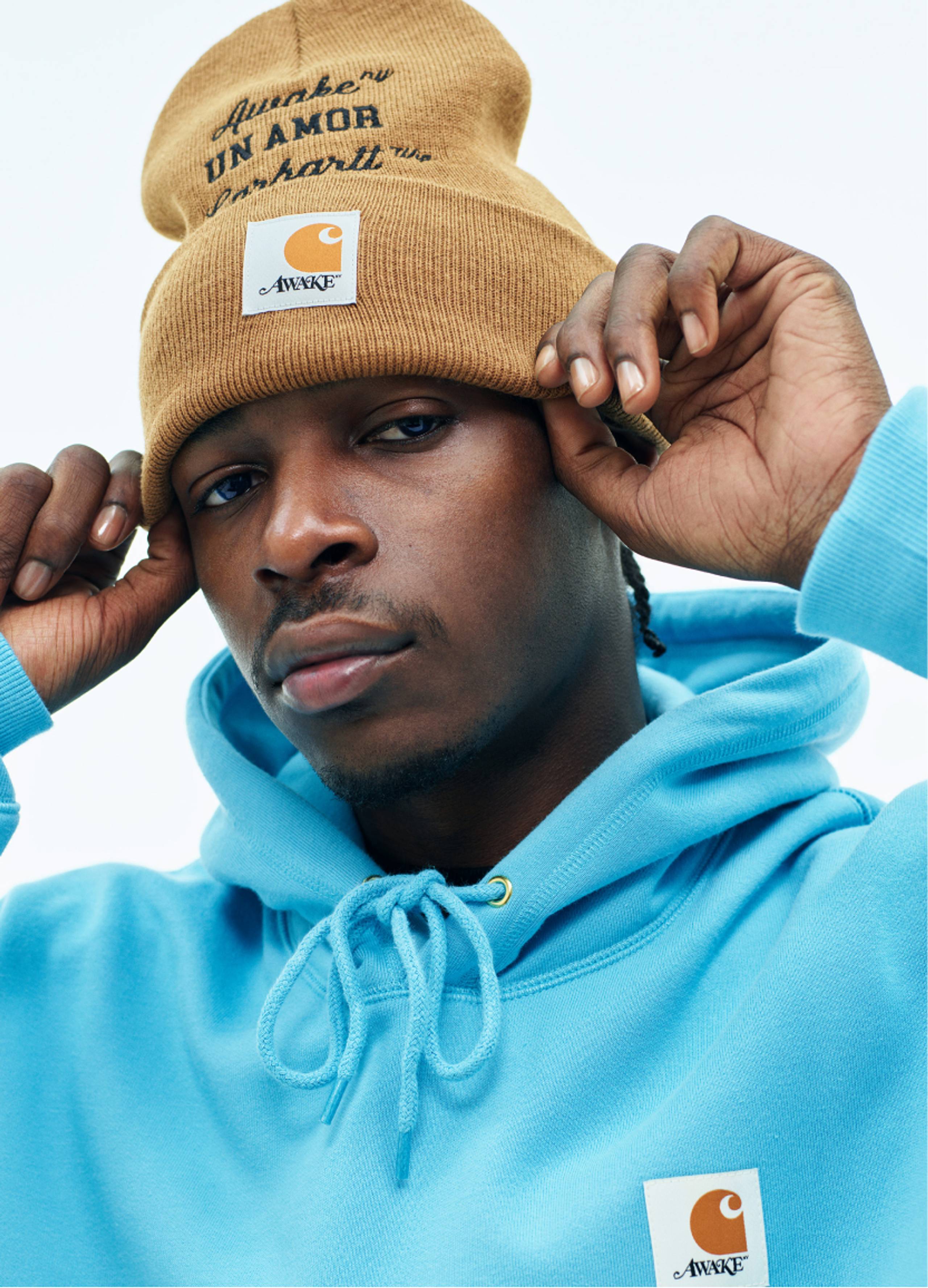 Model wearing Carhartt WIP x Awake NY Hoodie in Blue