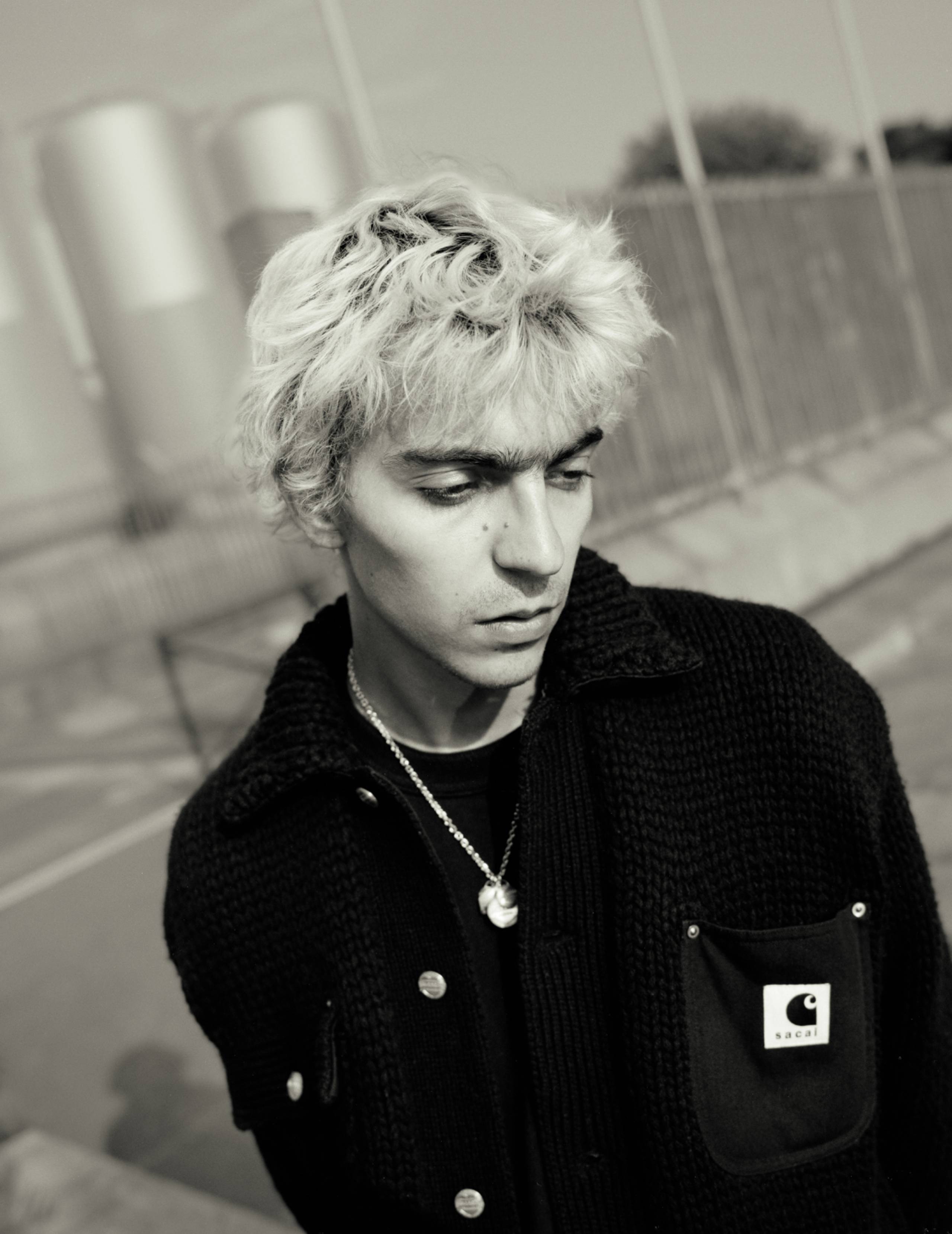 Model wearing items from the sacai x Carhartt WIP collection