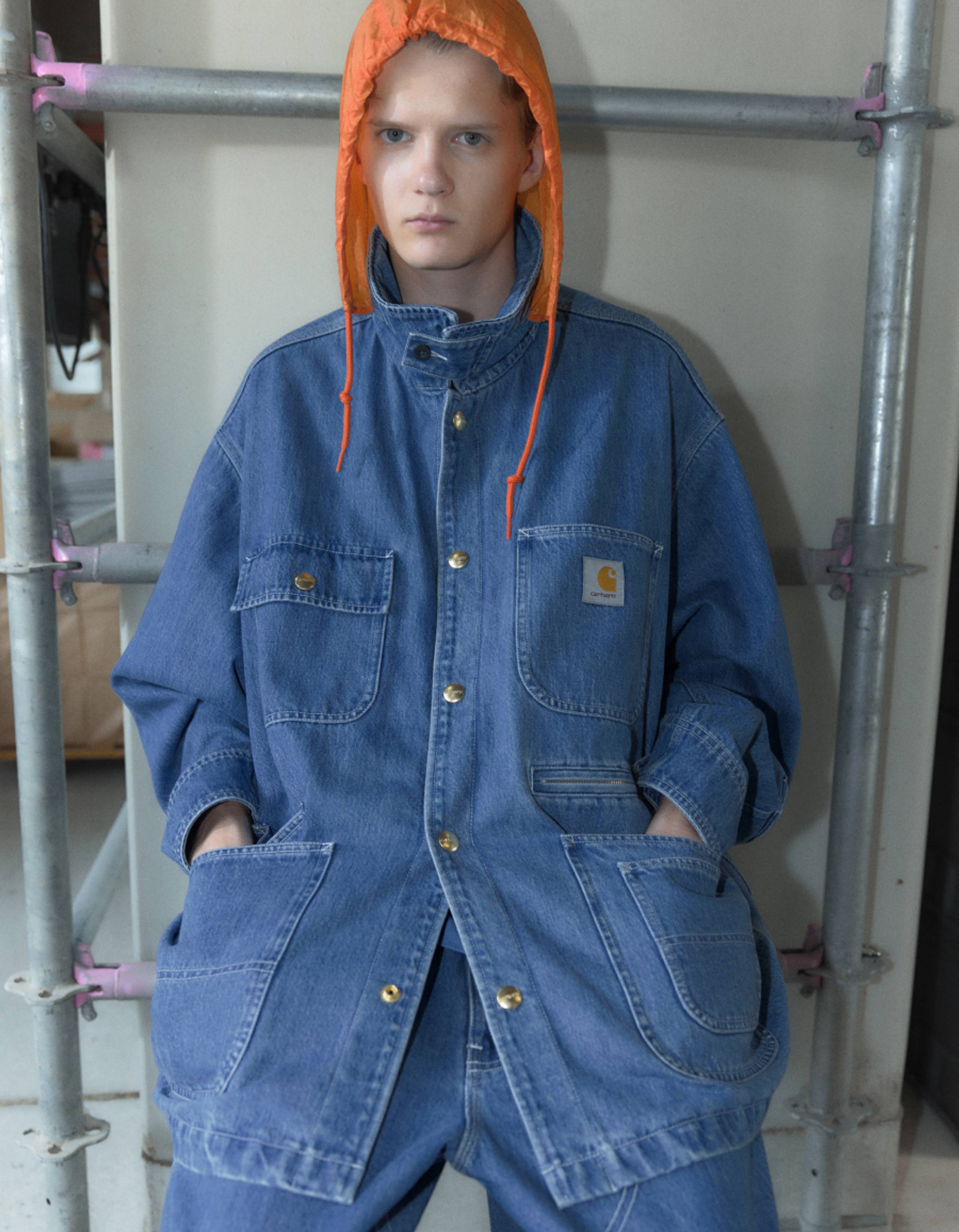 Model wearing Carhartt WIP x INVINCIBLE® Denim Chore Coat