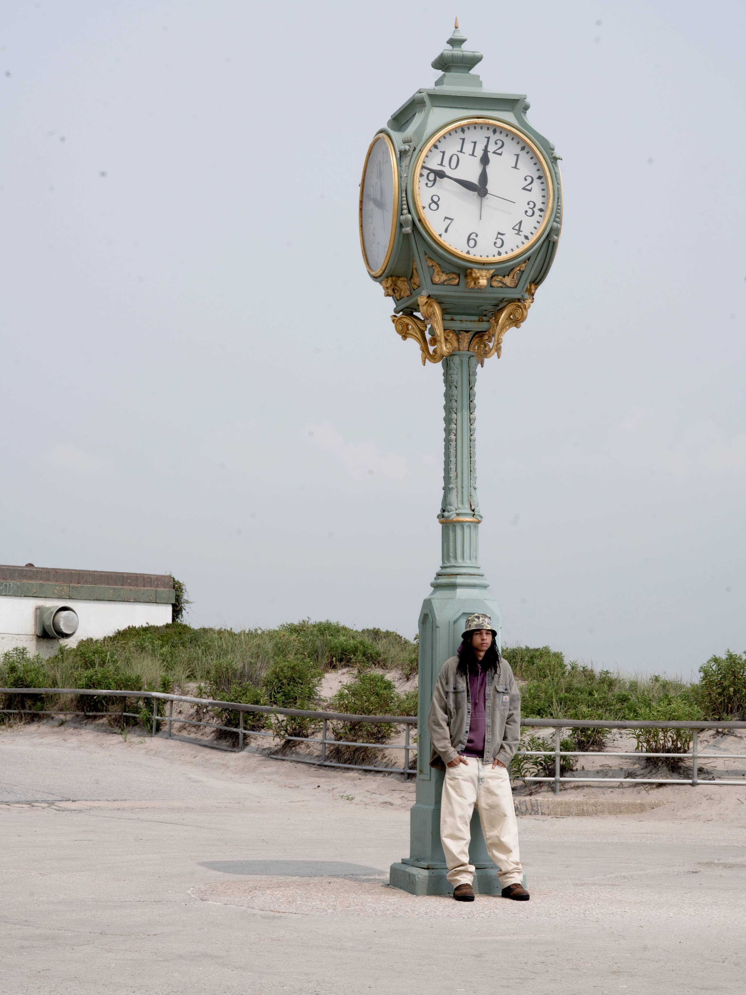 Model wearing a Tigan Shirt Jacket in Blue Garment Dyed and Landon Pant in Blue Sand Bleached in a parking lot