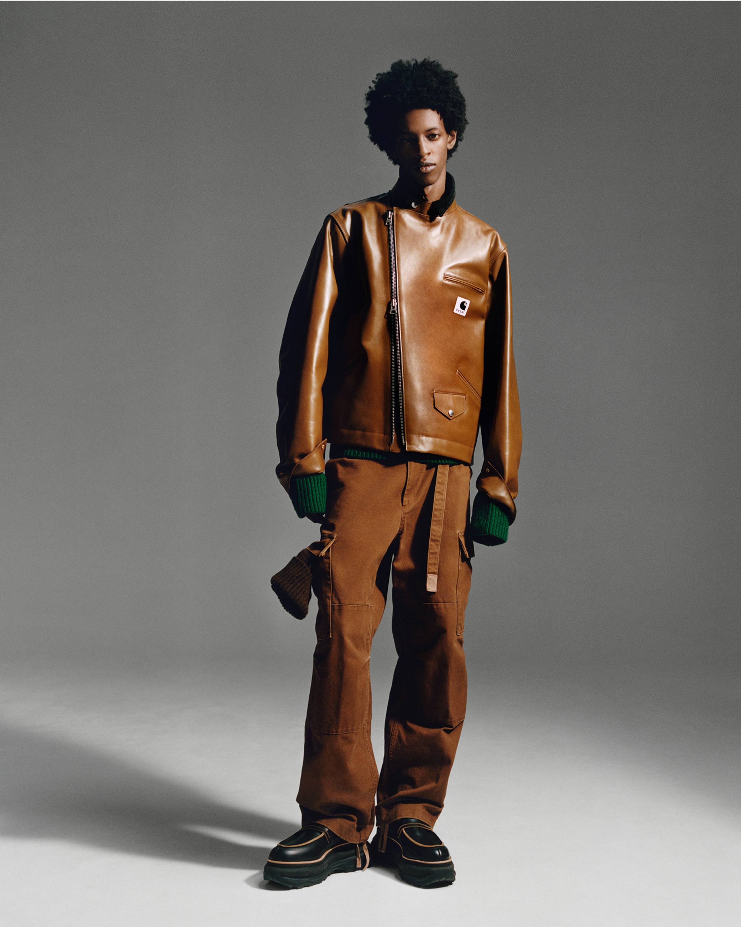 Person wearing a brown sacai x Carhartt WIP zip up leather jacket and brown pants