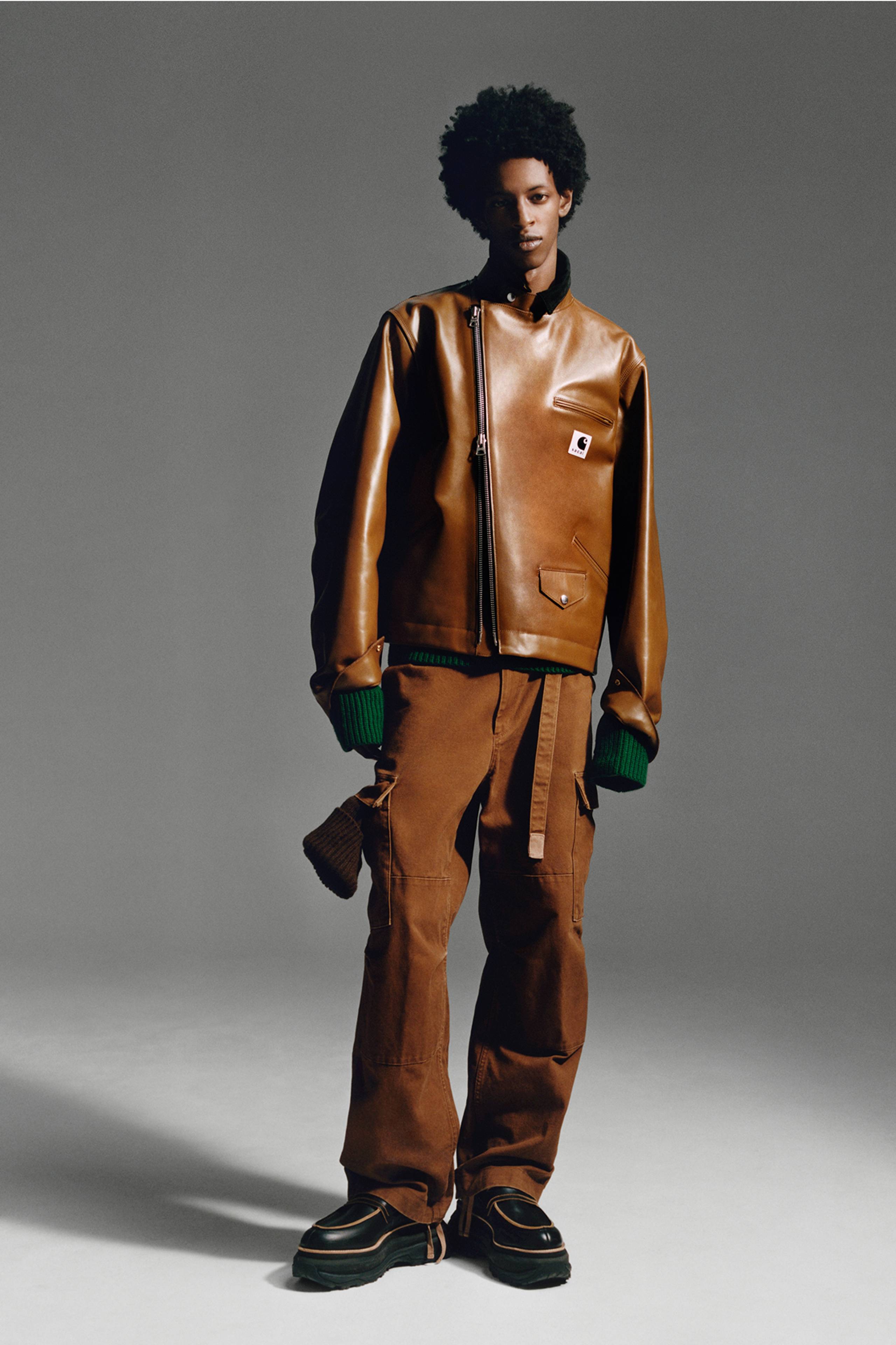 Person wearing a brown sacai x Carhartt WIP zip up leather jacket and brown pants