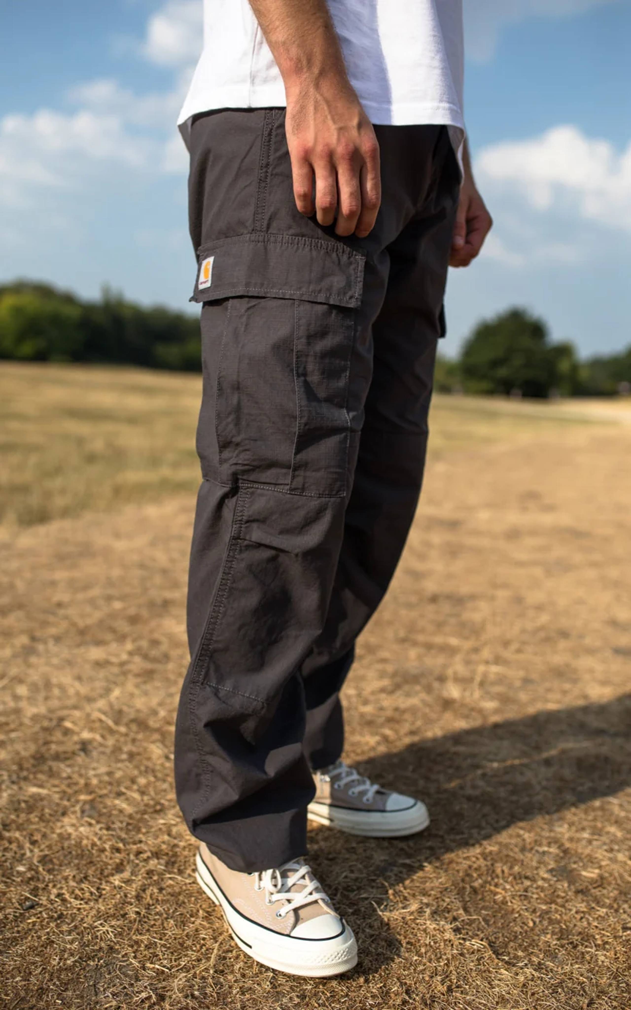 Model wearing dark grey Carhartt WIP cargo pants